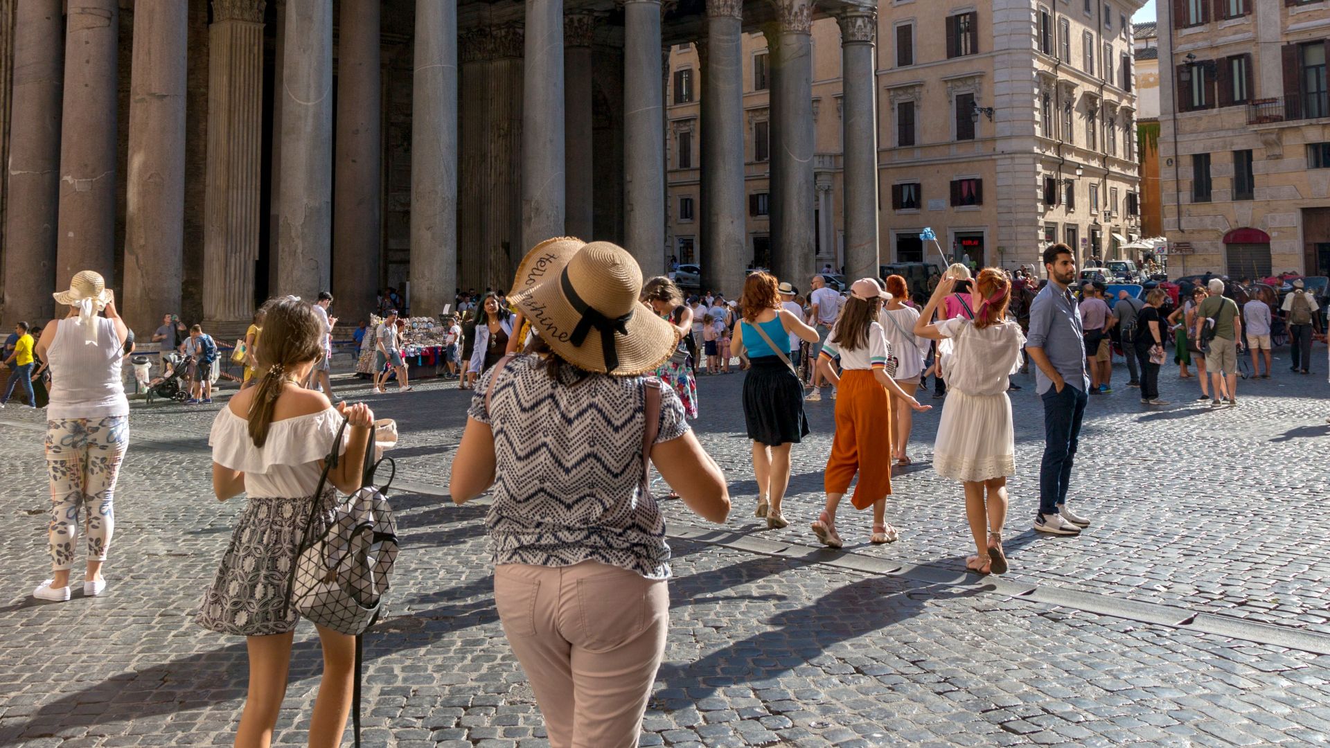 A vibrant scene of tourists visiting the iconic Pantheon in Rome, Italy, on a sunny day.