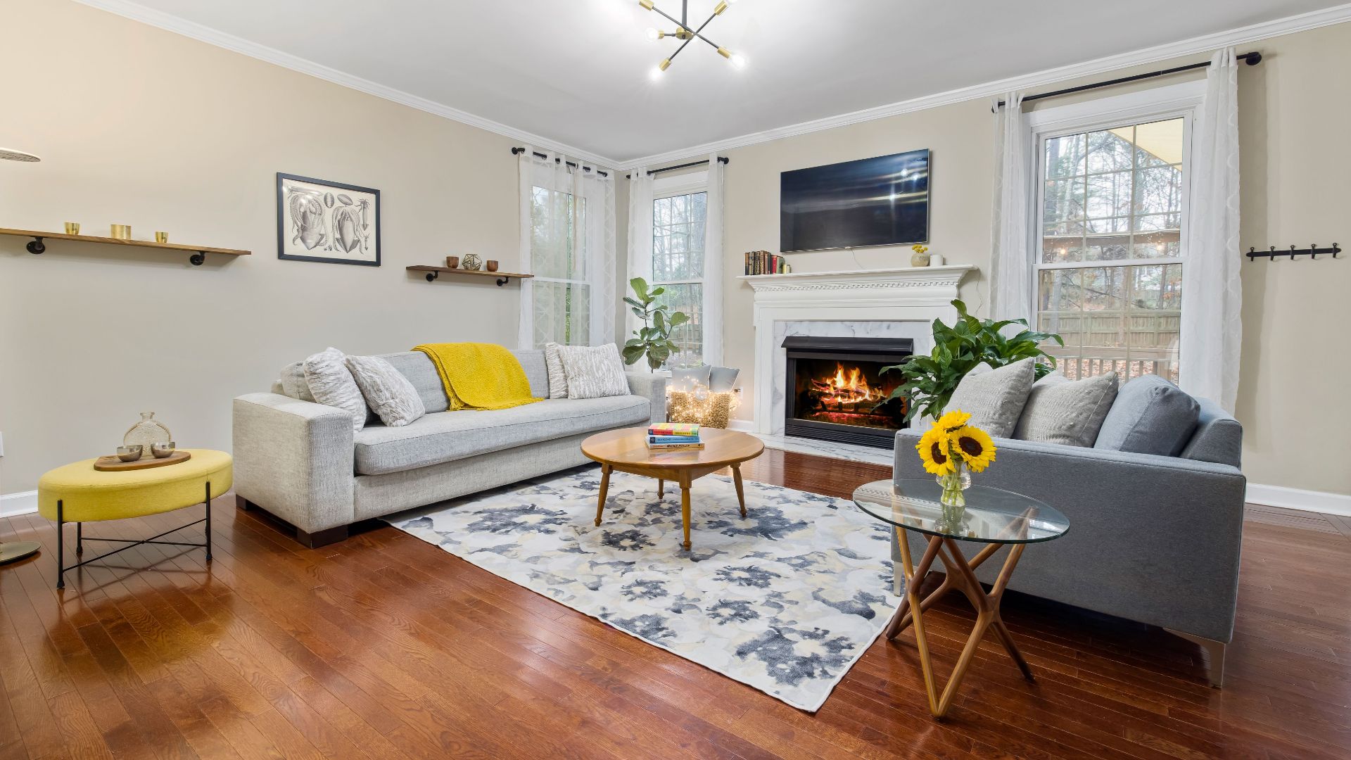 Bright and stylish living room featuring a modern fireplace, cozy sofa, and elegant decor.