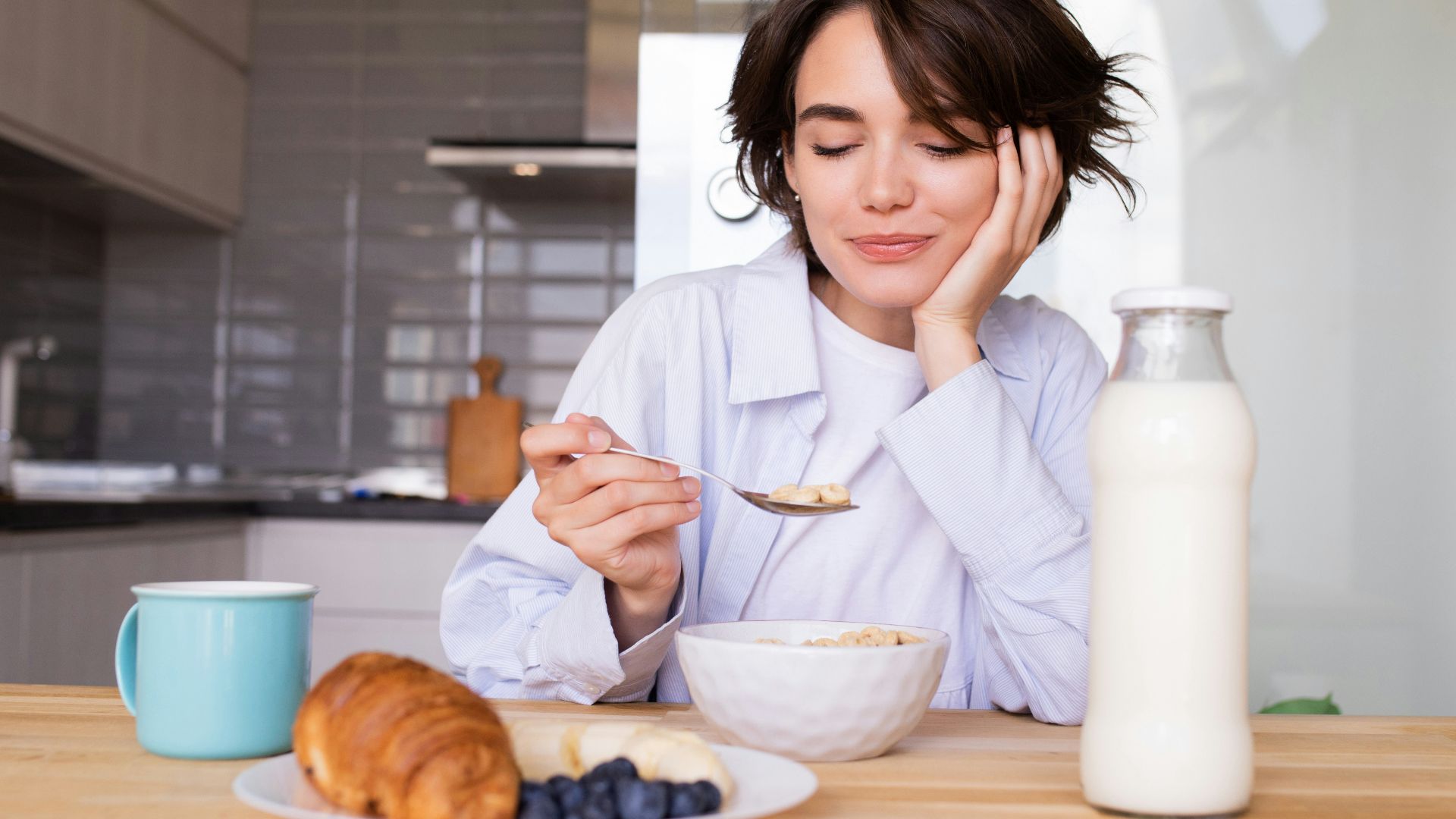 a woman sitting at a table with a plate of food