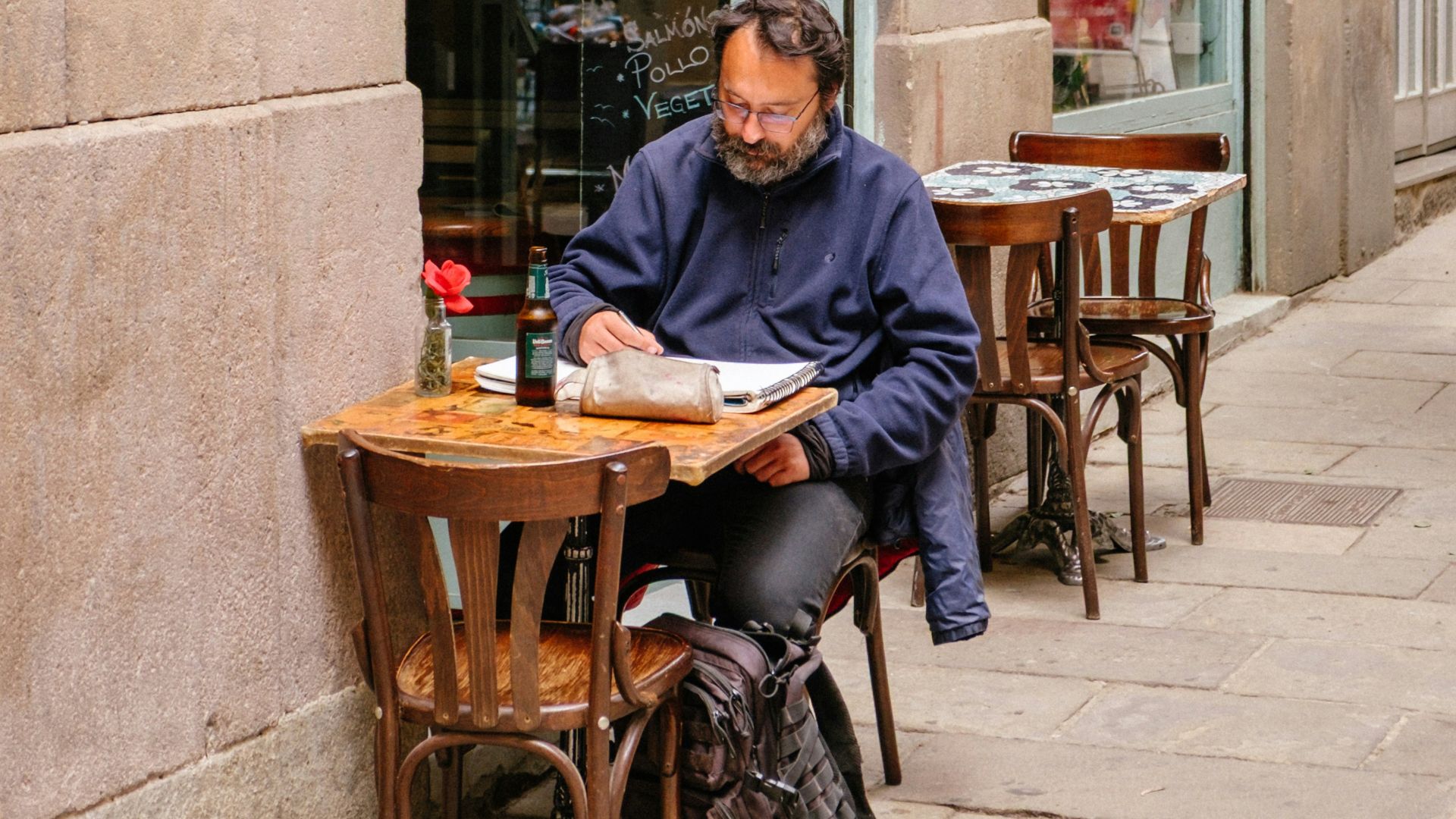Man reading at an outdoor cafe