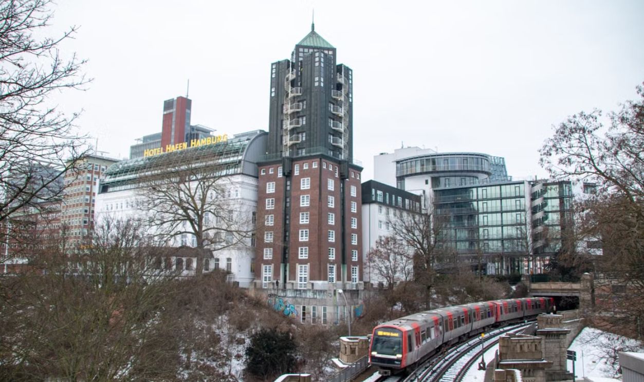 Snow-covered Hamburg with urban architecture and train in winter scene