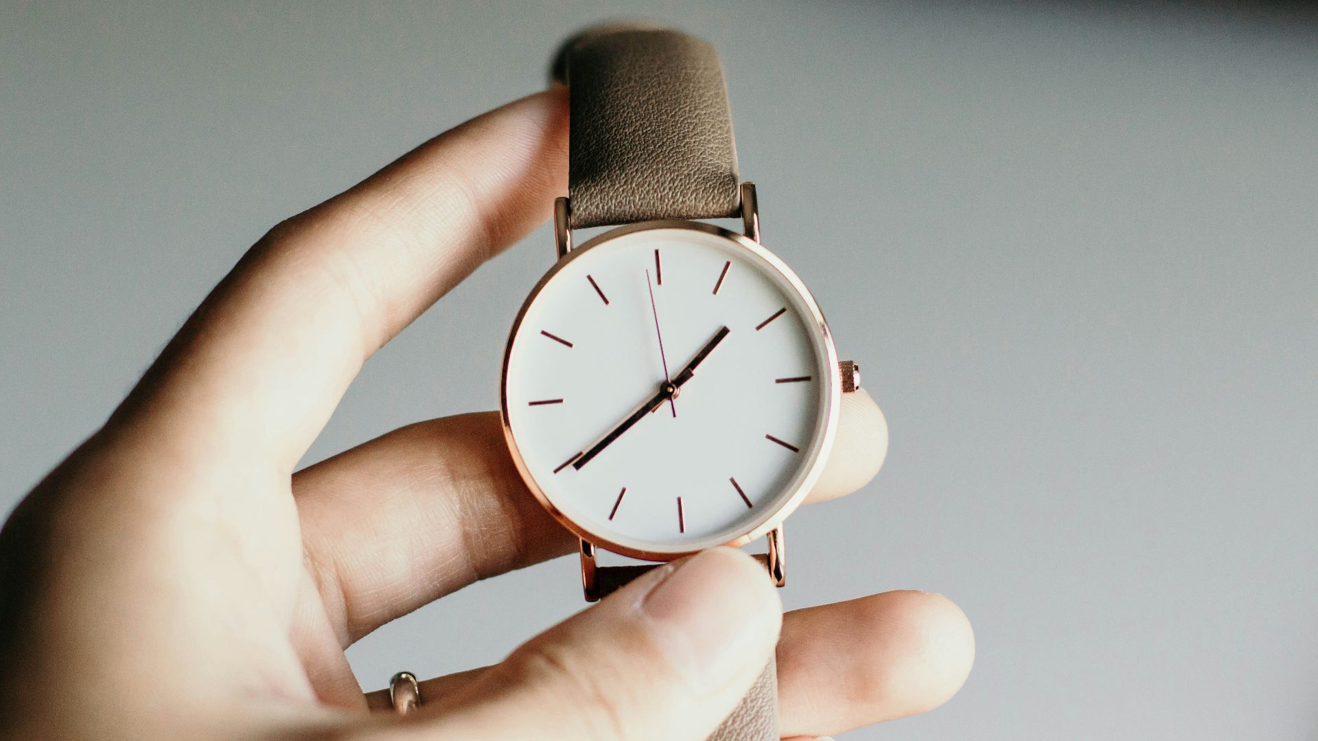 person holding analog watch