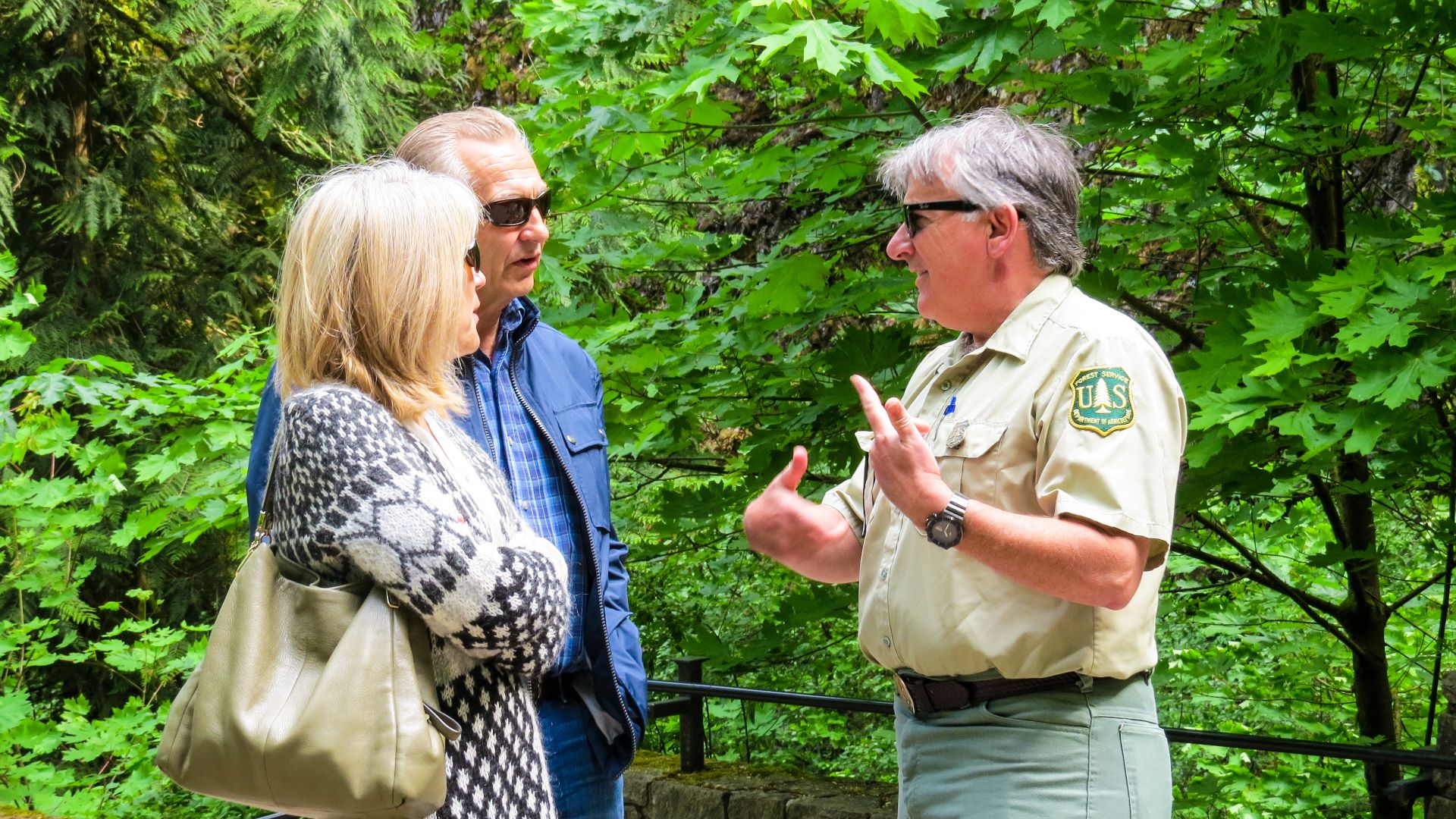 US Forest Service Field Ranger talking with Couple at Multnomah Falls Viewing Area on the Columbia River Gorge National Scenic Area.