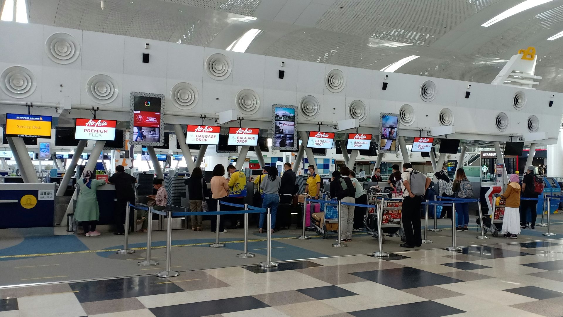 a group of people waiting in line at an airport