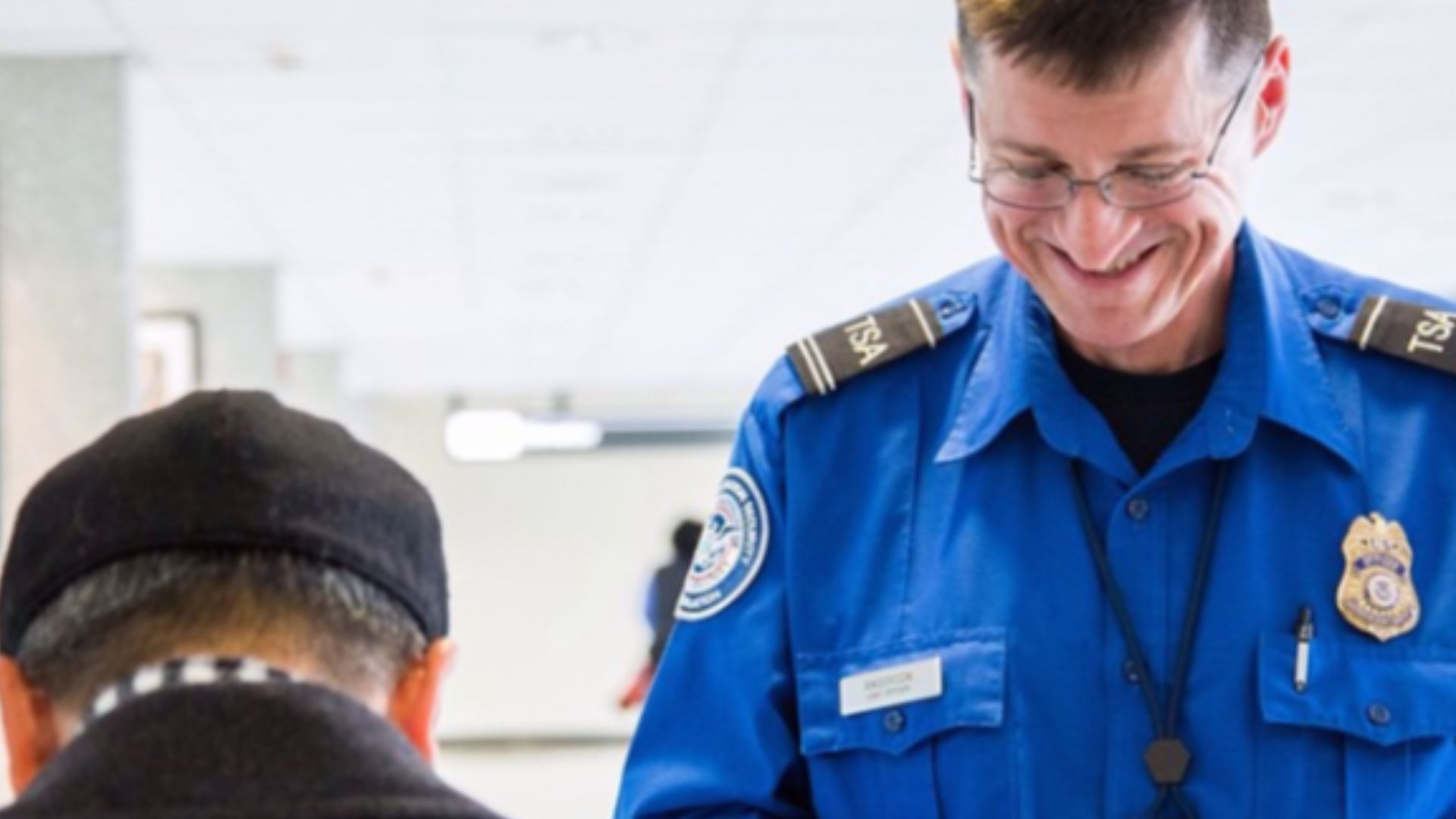 TSA officer checking a passenger's ID