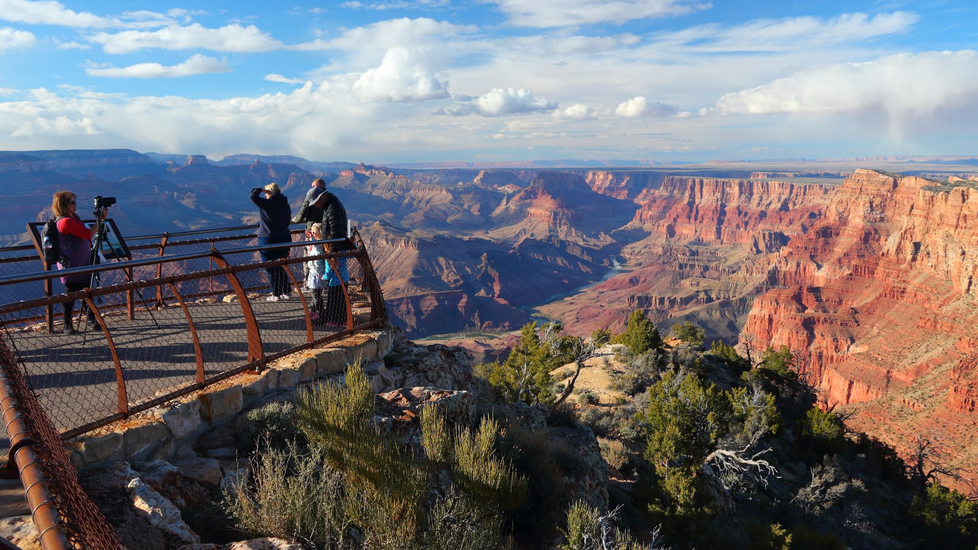American nature. Tourists at Grand Canyon Navajo Point viewpoint terrace, Grand Canyon National Park, Arizona, USA. Late afternoon light at South Rim of Gran Canyon.