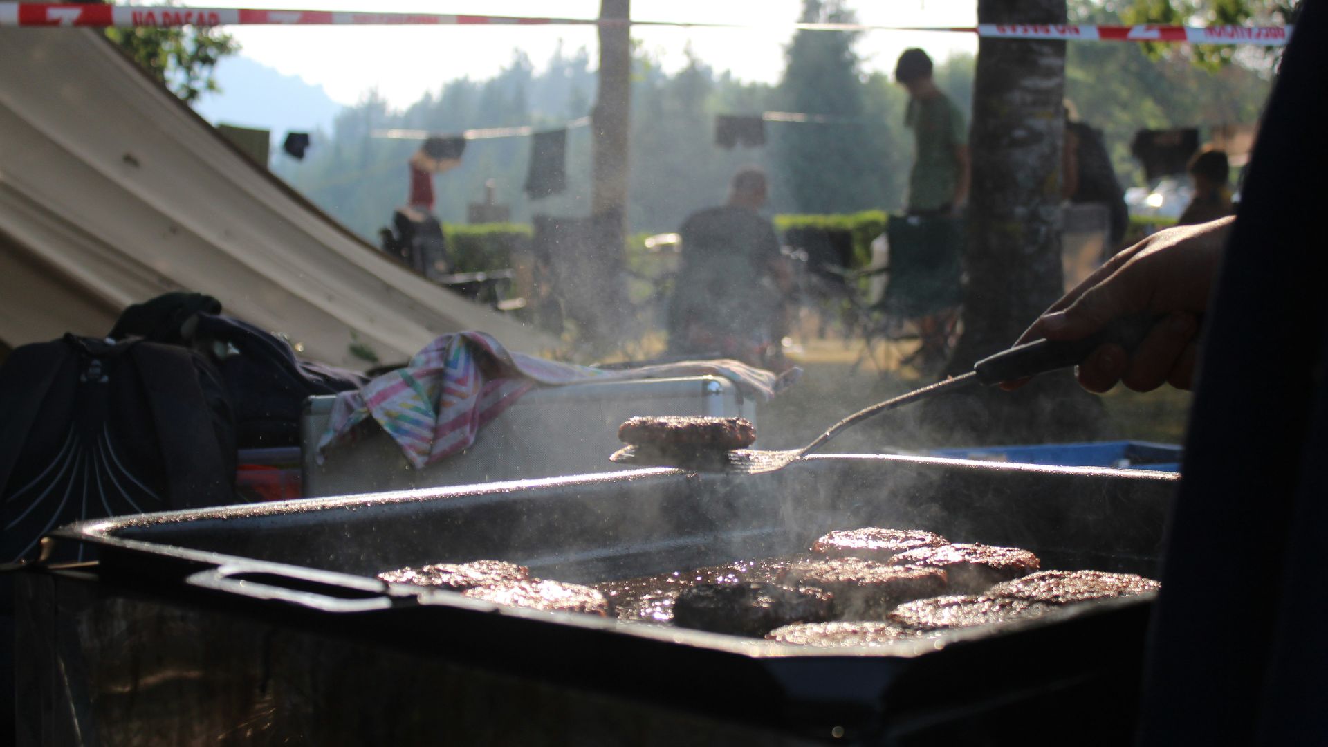 a person cooking food on a grill