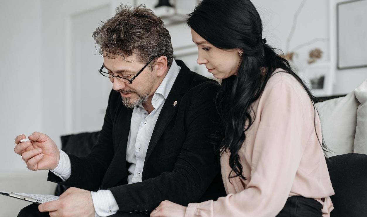 Business professionals discussing documents in a modern office setting