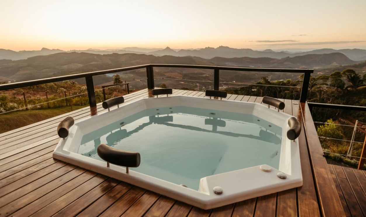 Relaxing hot tub with stunning mountain view at sunset, perfect for luxury retreats