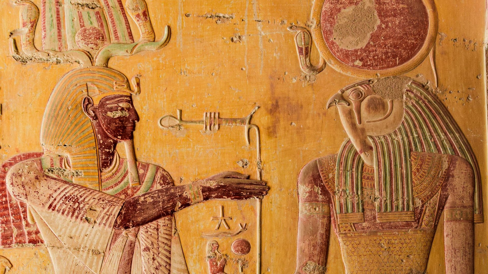 Detailed Egyptian relief depicting gods with hieroglyphs, highlighting ancient art.