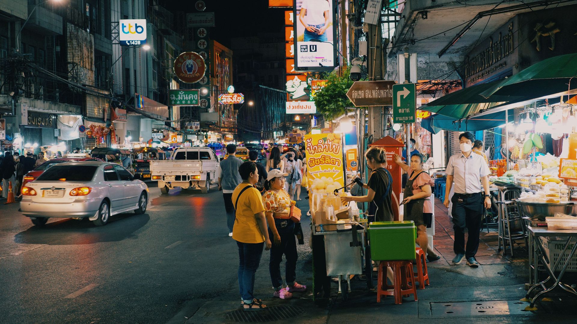 Lively urban night market with food stands and vibrant lights, showcasing city nightlife.