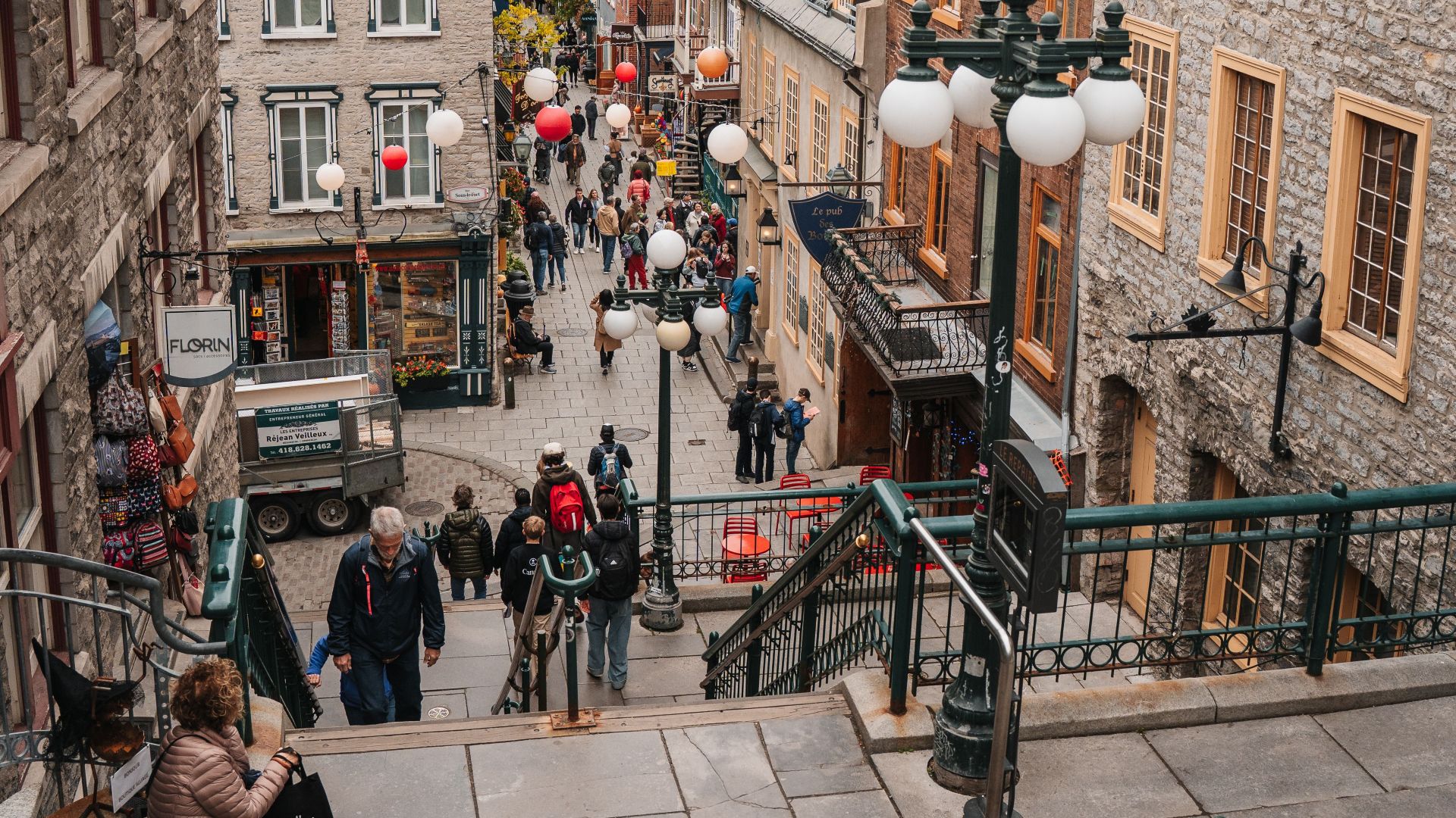 Explore the vibrant street life in Old Quebec City with autumn colors and historic architecture.