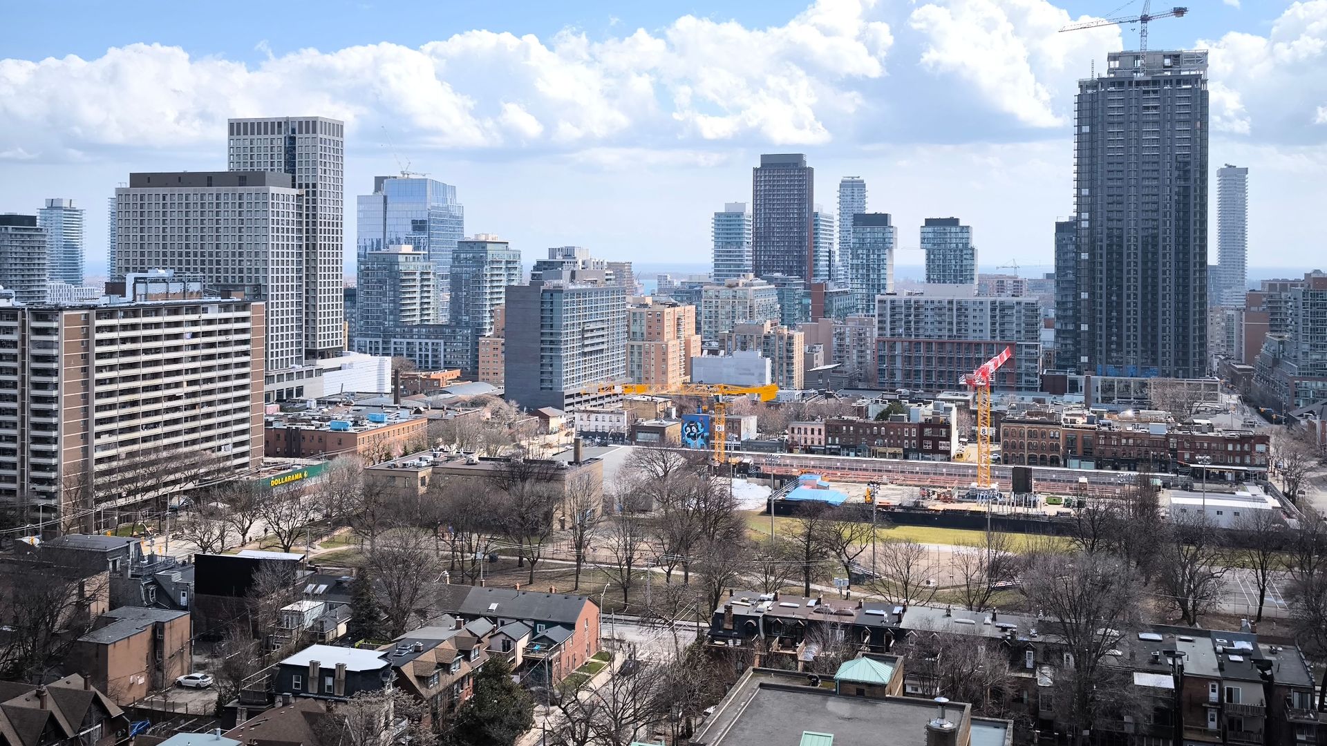 View of Toronto skyline showcasing modern skyscrapers and urban development under clear skies.
