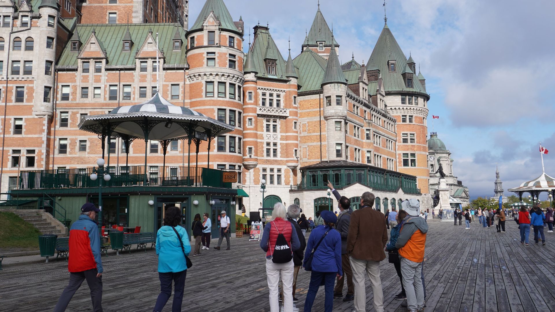 Visitors admire the iconic Château Frontenac on a clear day in Quebec City, Canada.