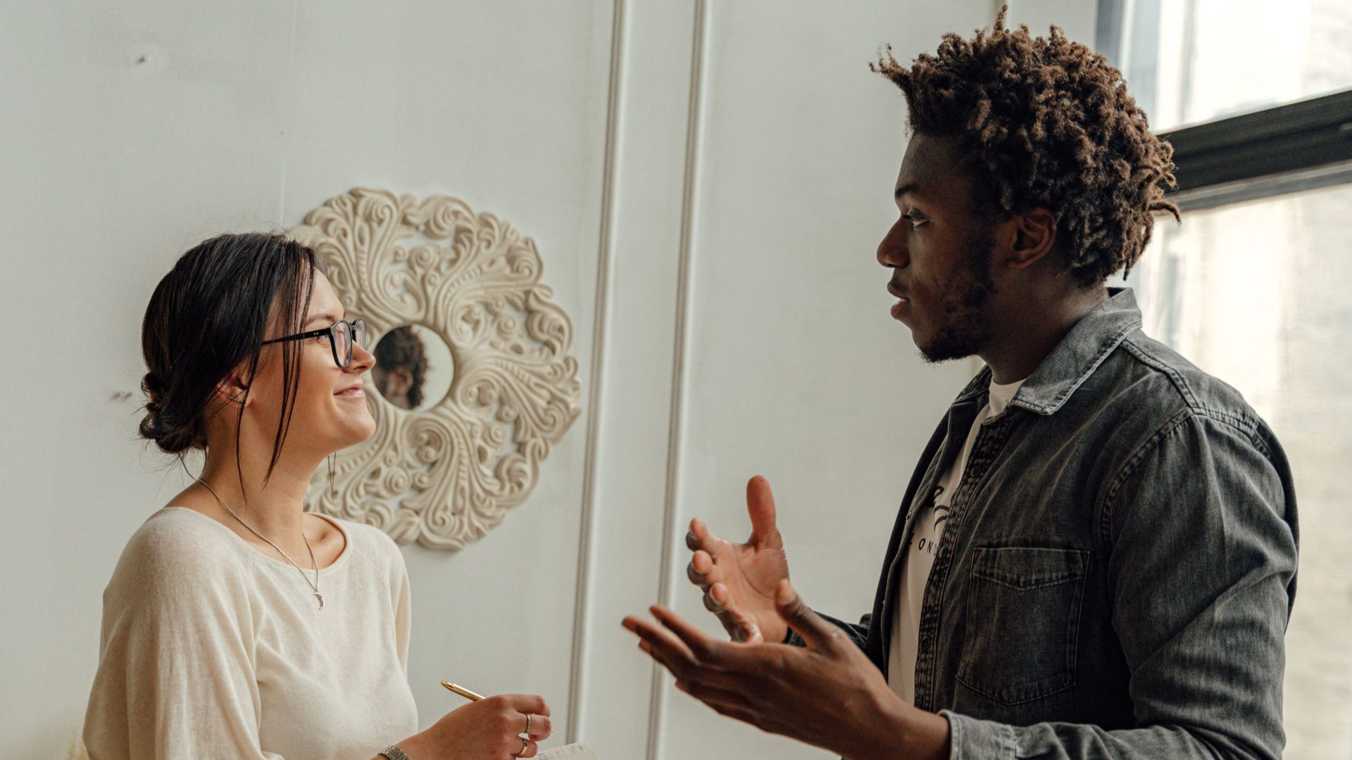 A man and woman engaging in a professional consultation in a stylish office setting, highlighting collaboration.