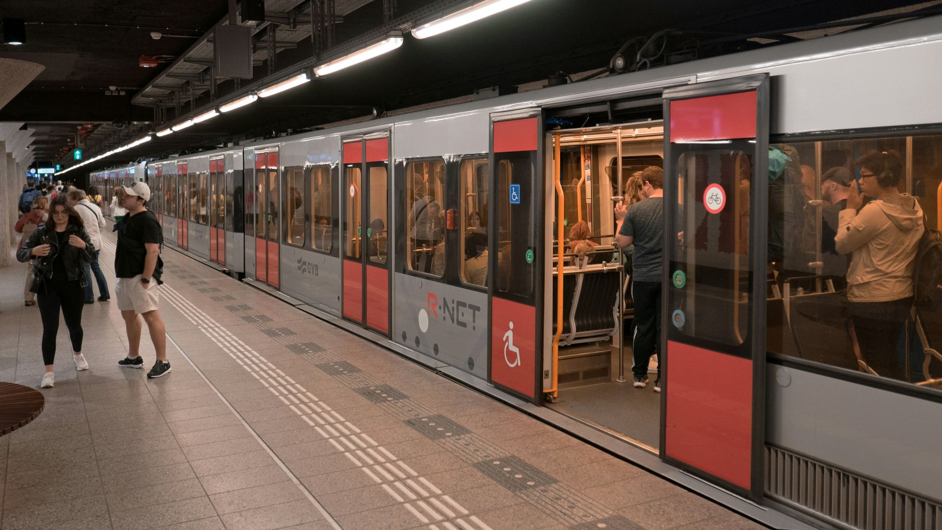 a group of people standing next to a train
