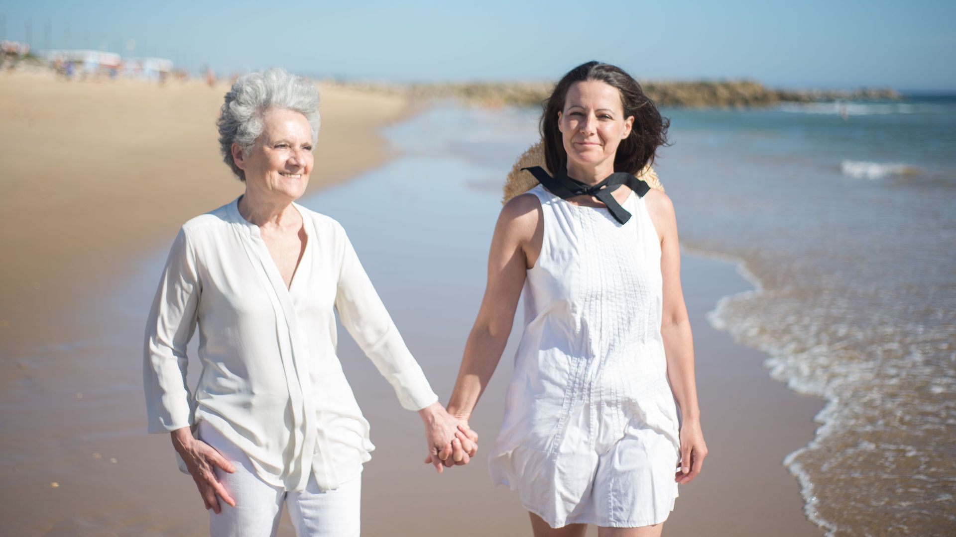 A heartwarming walk between mother and daughter on a sunny beach in Portugal.