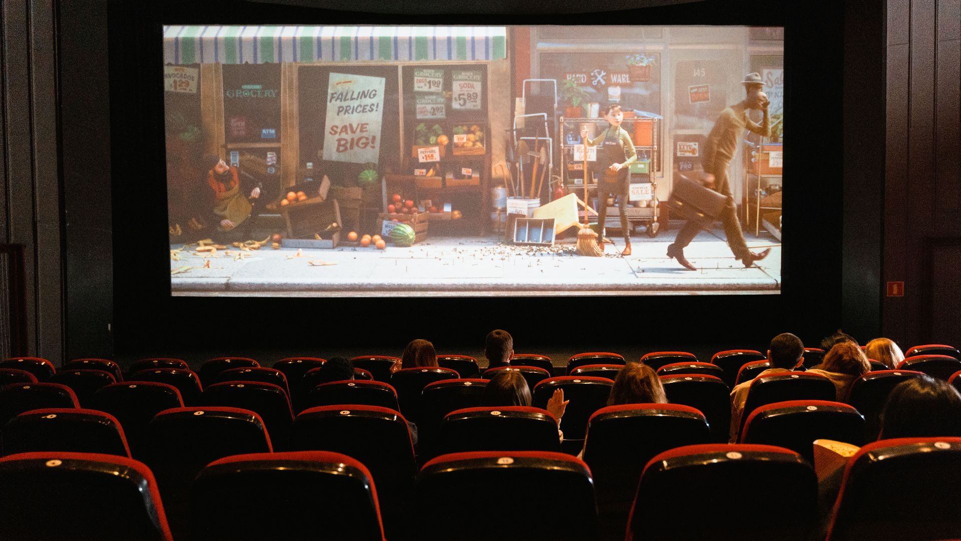 A cozy indoor movie theater showing an animated film to a small audience.