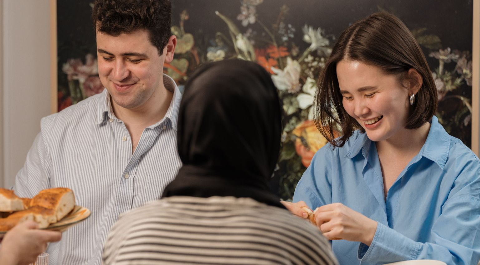 A cheerful group of friends enjoying a dinner party with delicious food and laughter.