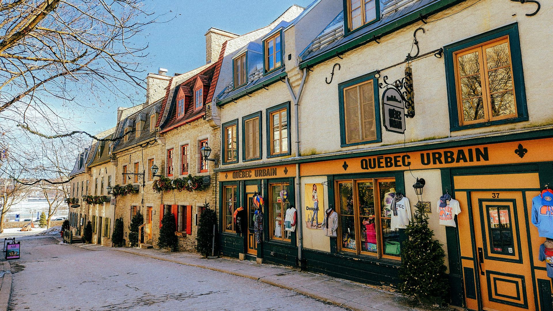 Picturesque winter scene of historic Rue du Petit-Champlain in Quebec City, showcasing colorful colonial-style architecture.