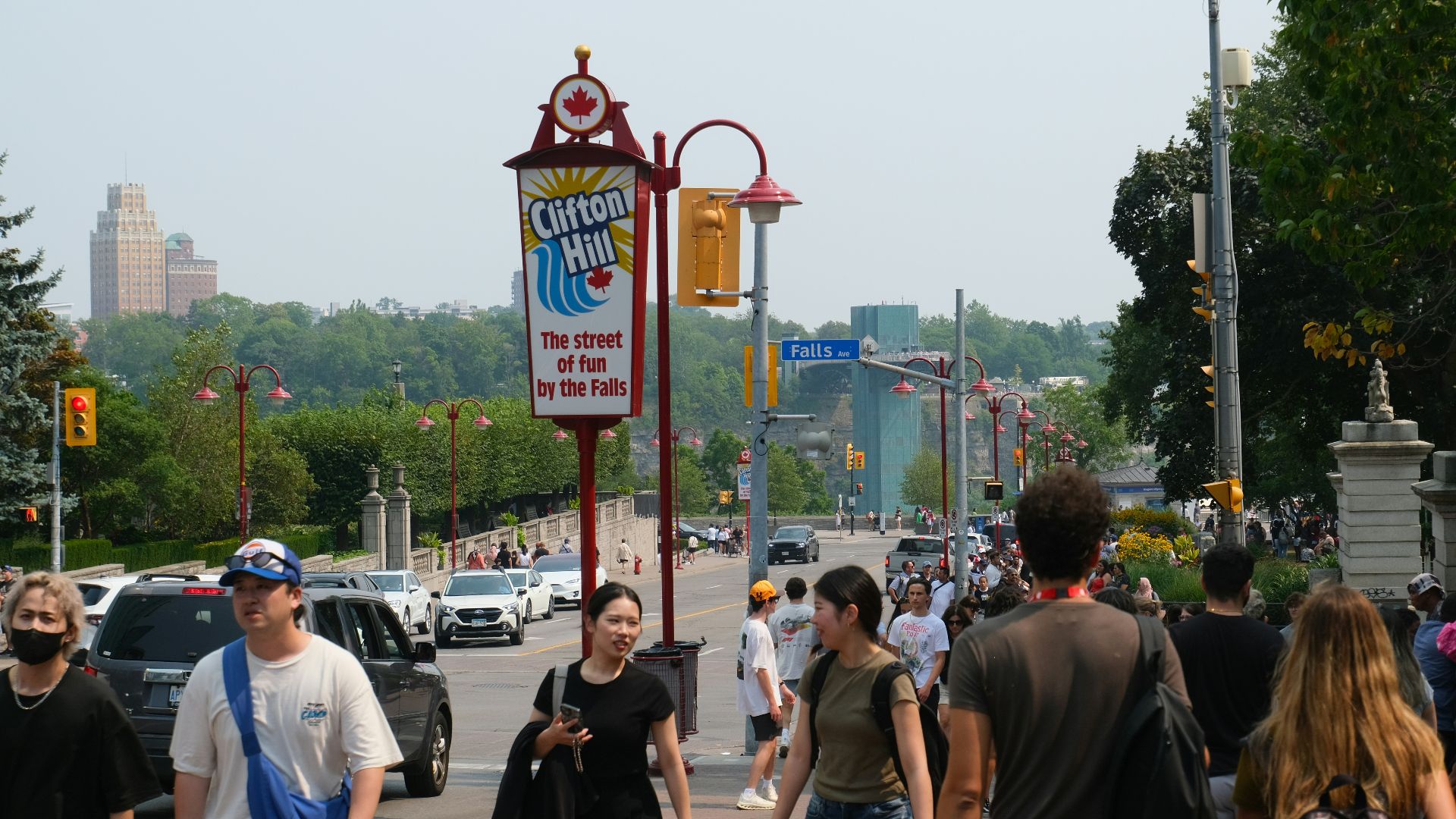 Crowd of people walking near a sign for clifton hill.