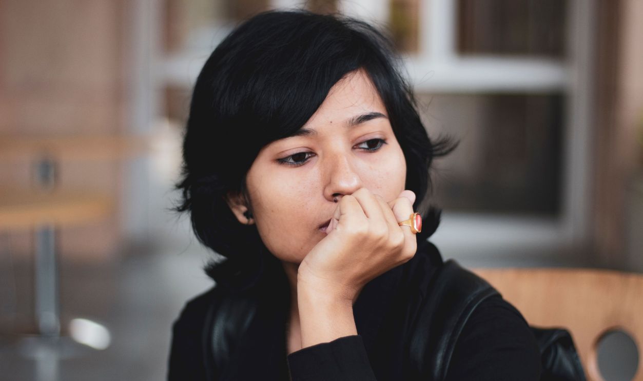 Portrait of a thoughtful woman indoors