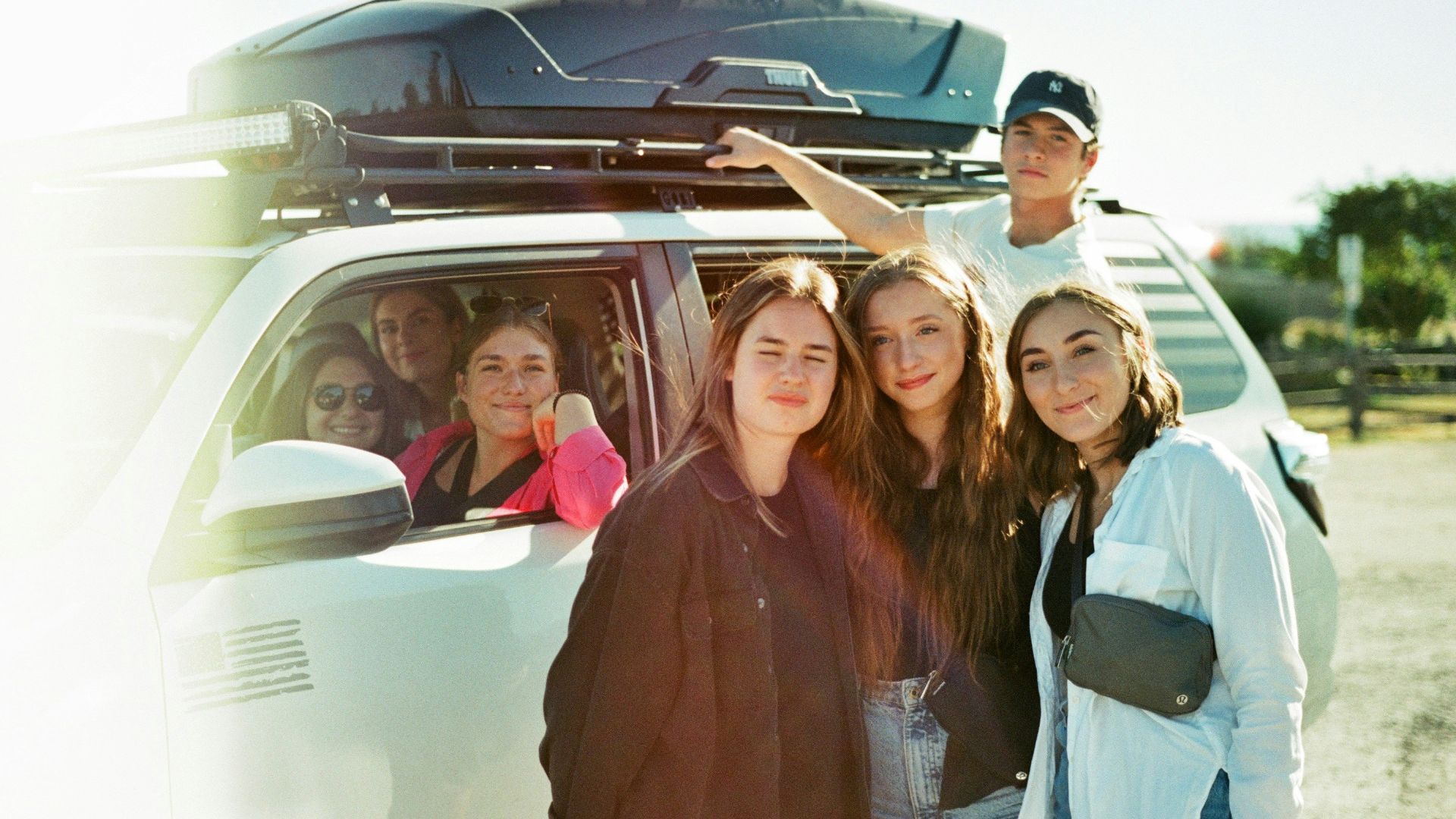 a group of people standing in front of a van