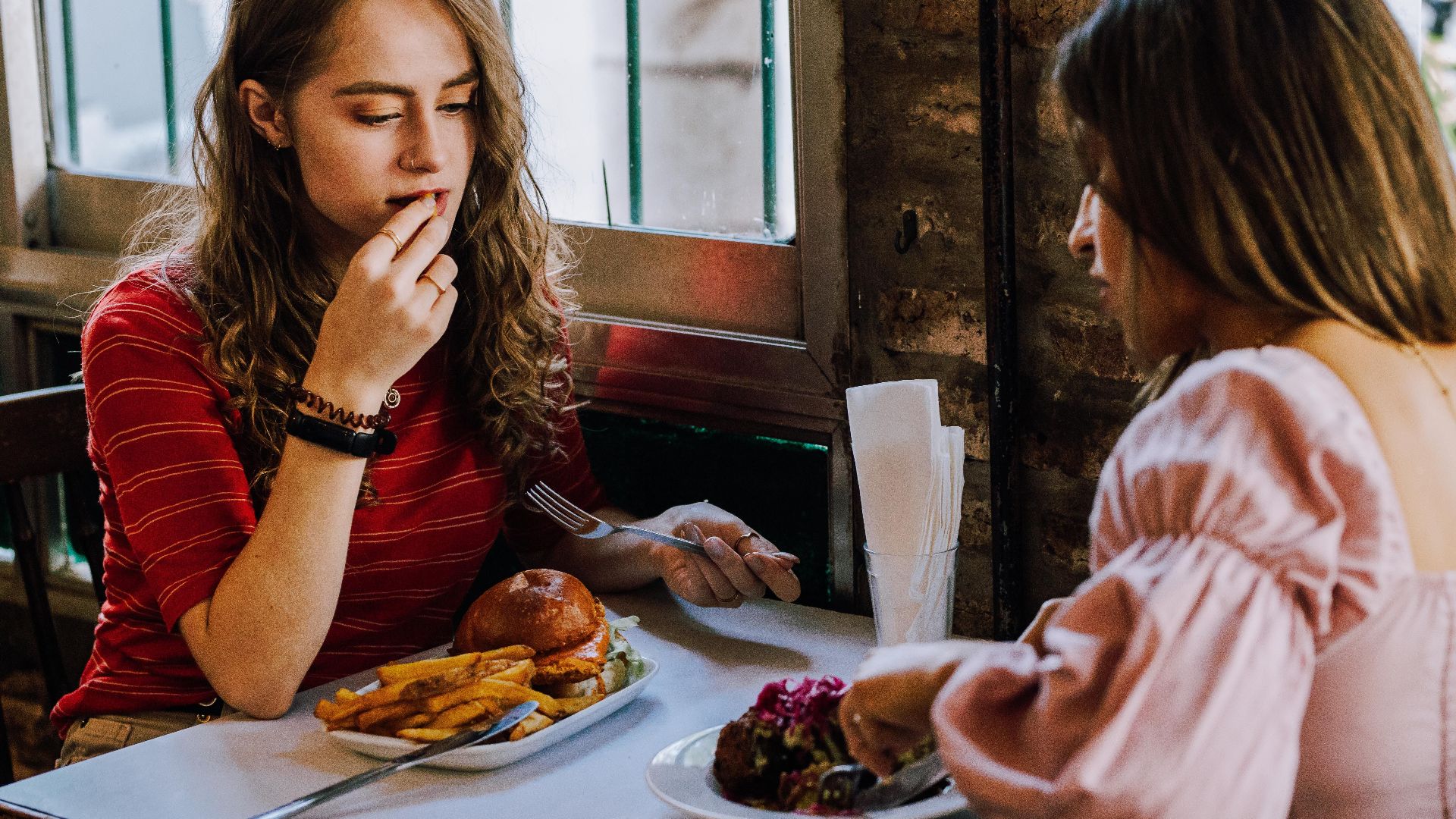 Two women enjoying lunch at a cozy cafe in Buenos Aires, Argentina.
