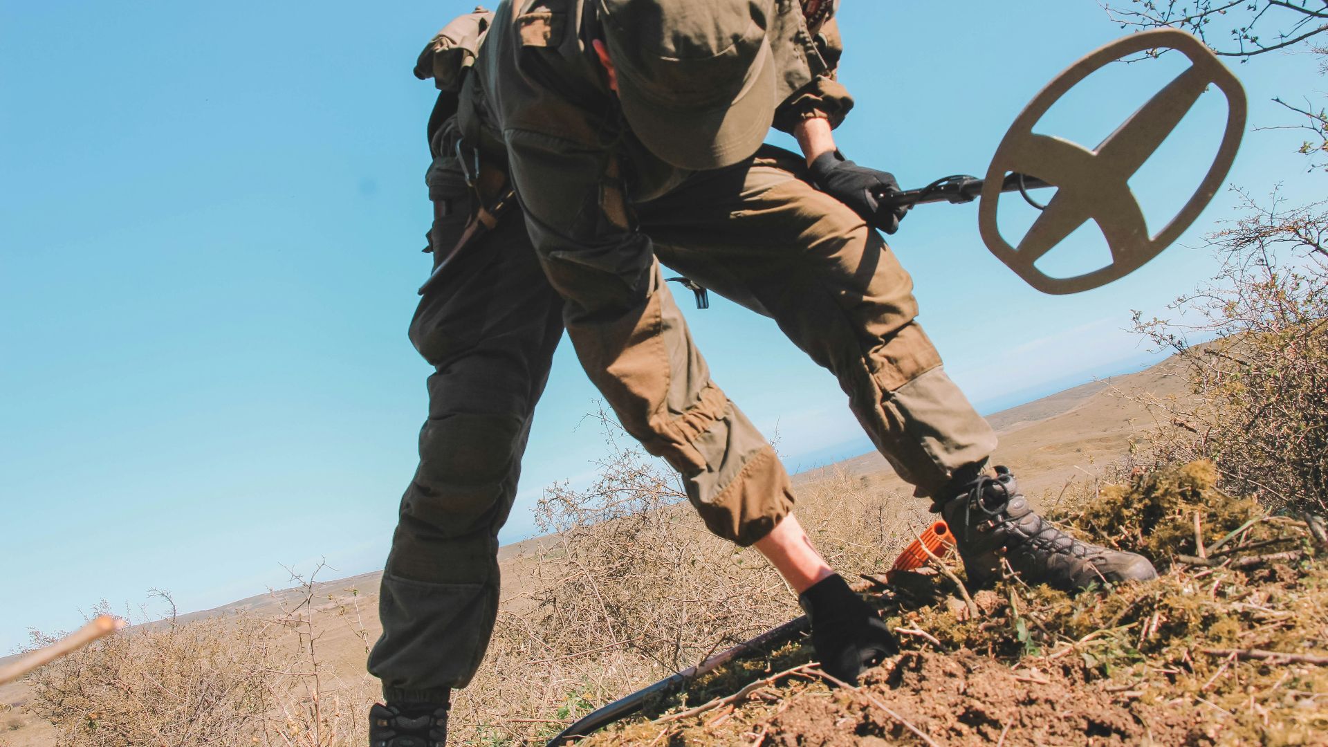 officer holding metal detector