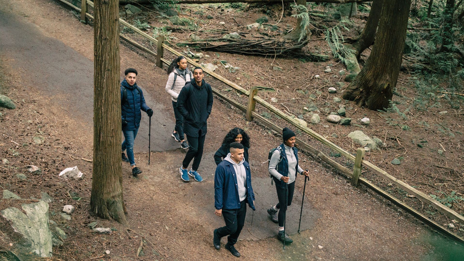 A group of friends enjoying a hike on a scenic forest trail, embracing adventure and nature.
