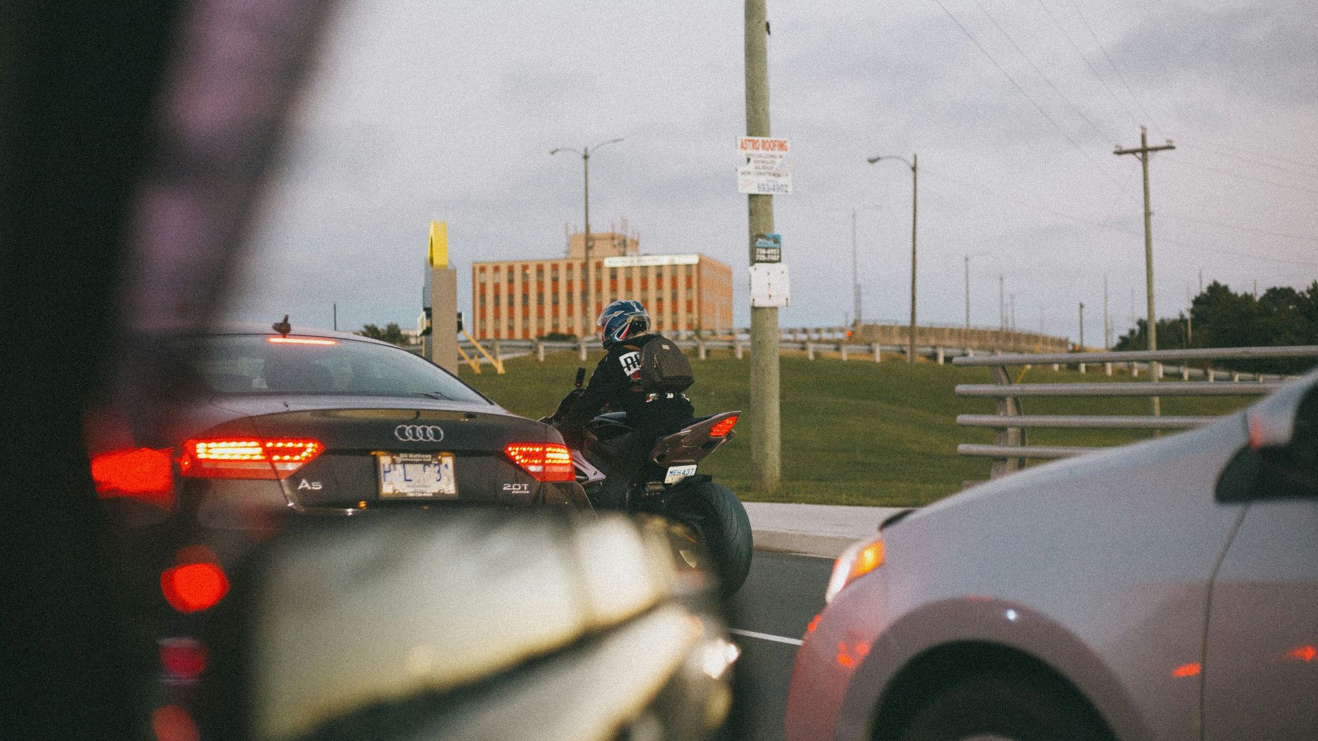 man in black motorcycle helmet riding motorcycle on road during daytime