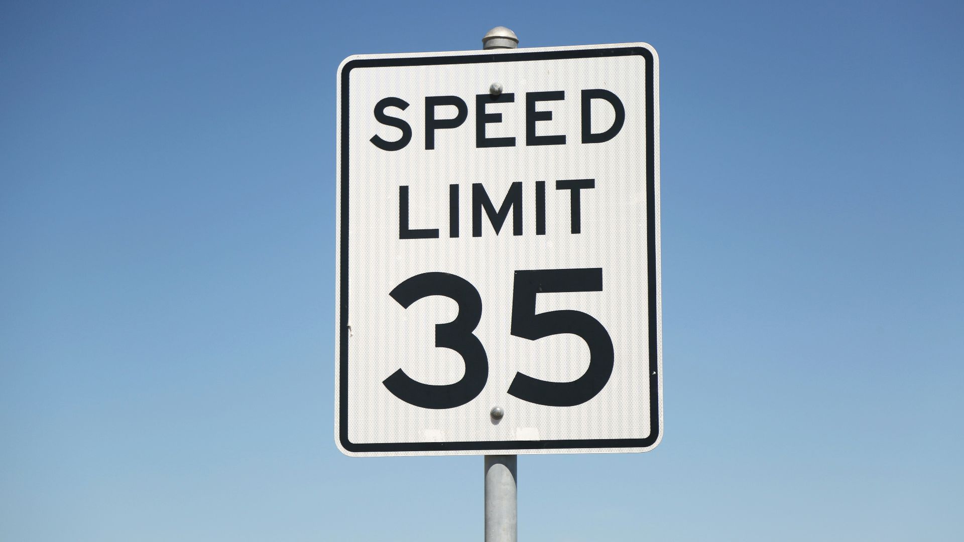 A speed limit sign on the side of the road