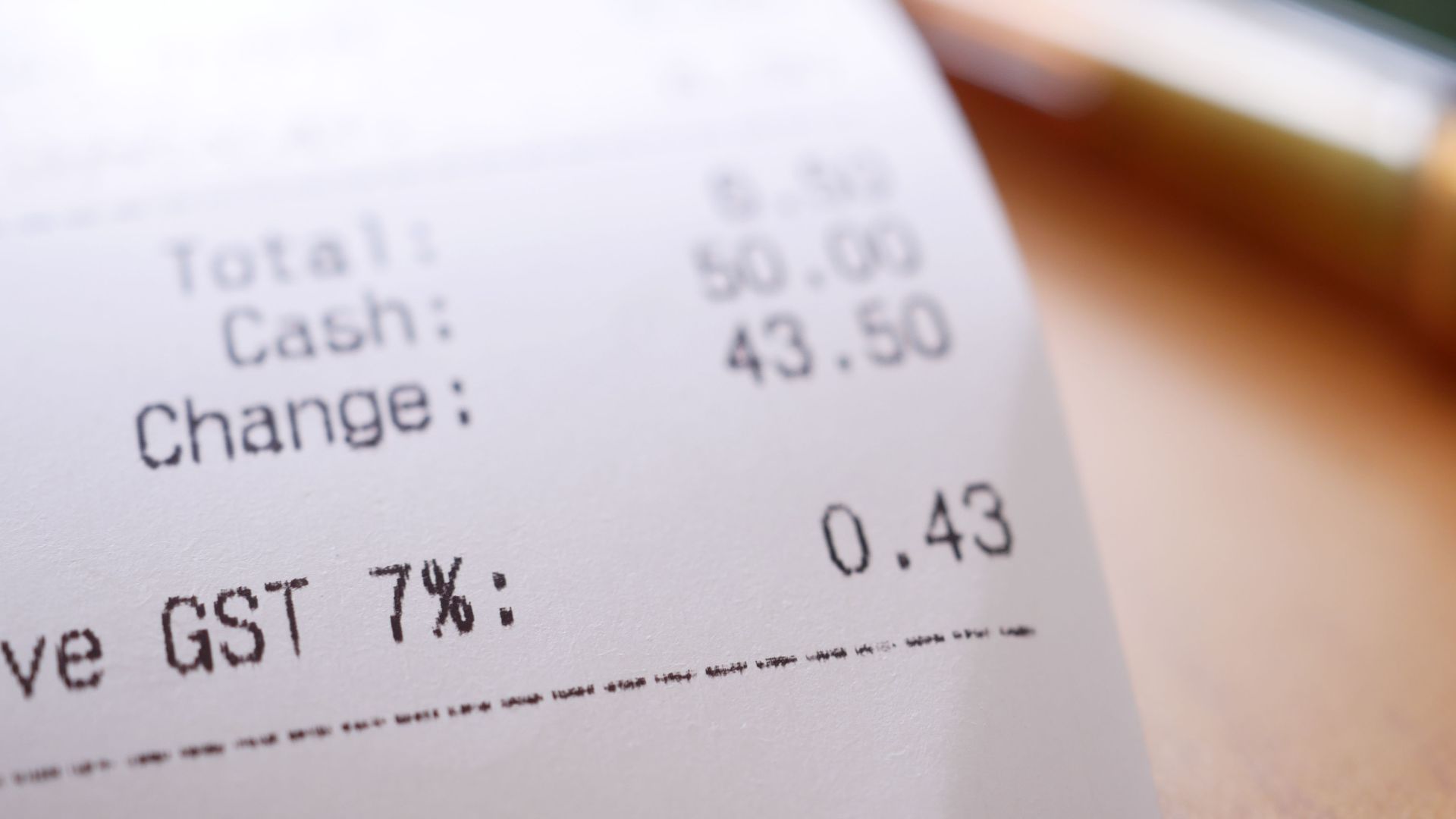 Detailed close-up image of a shopping receipt showing GST and total changes.