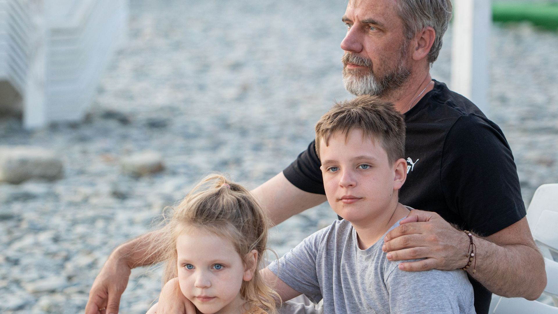 A family enjoys a relaxing summer day at the beach, embracing togetherness and leisure.