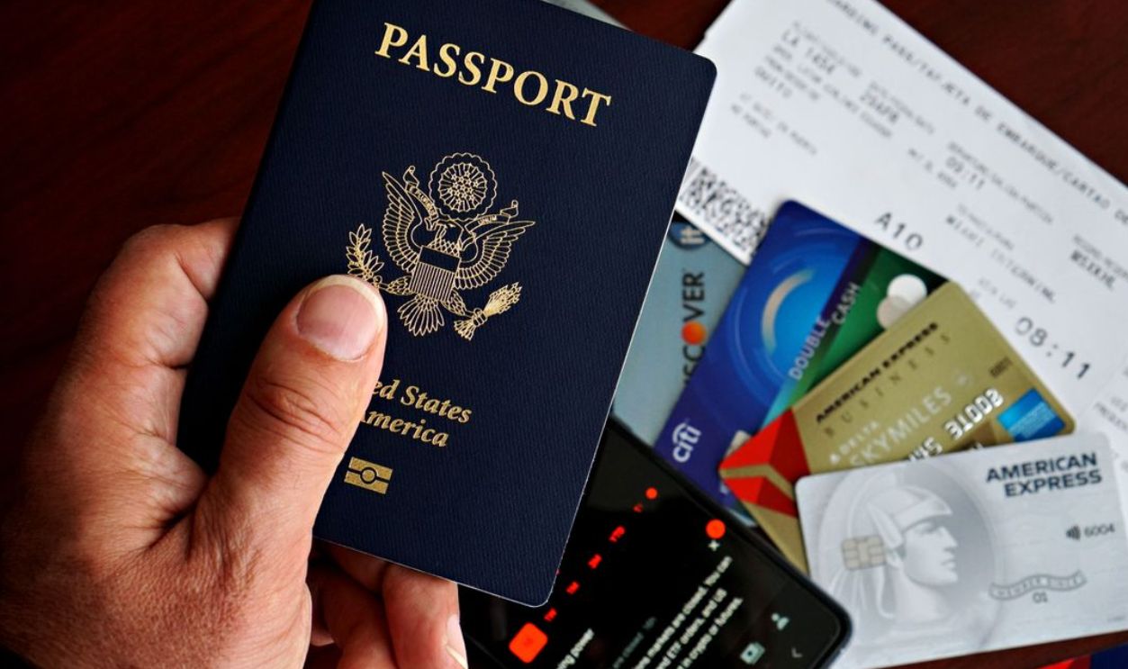 US passport with credit cards and travel documents on a table, travel preparation concept