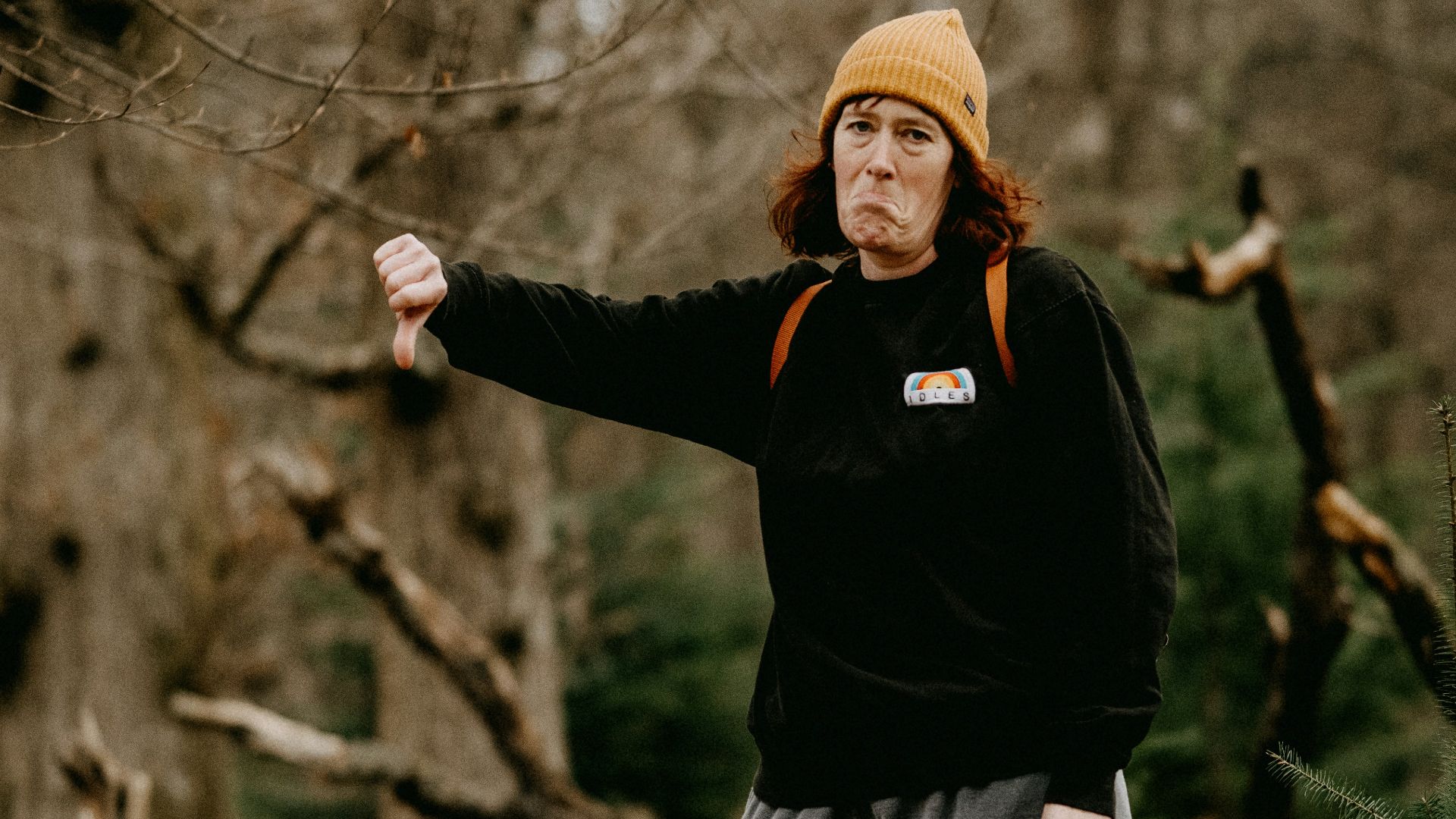 a man standing on a log in the woods