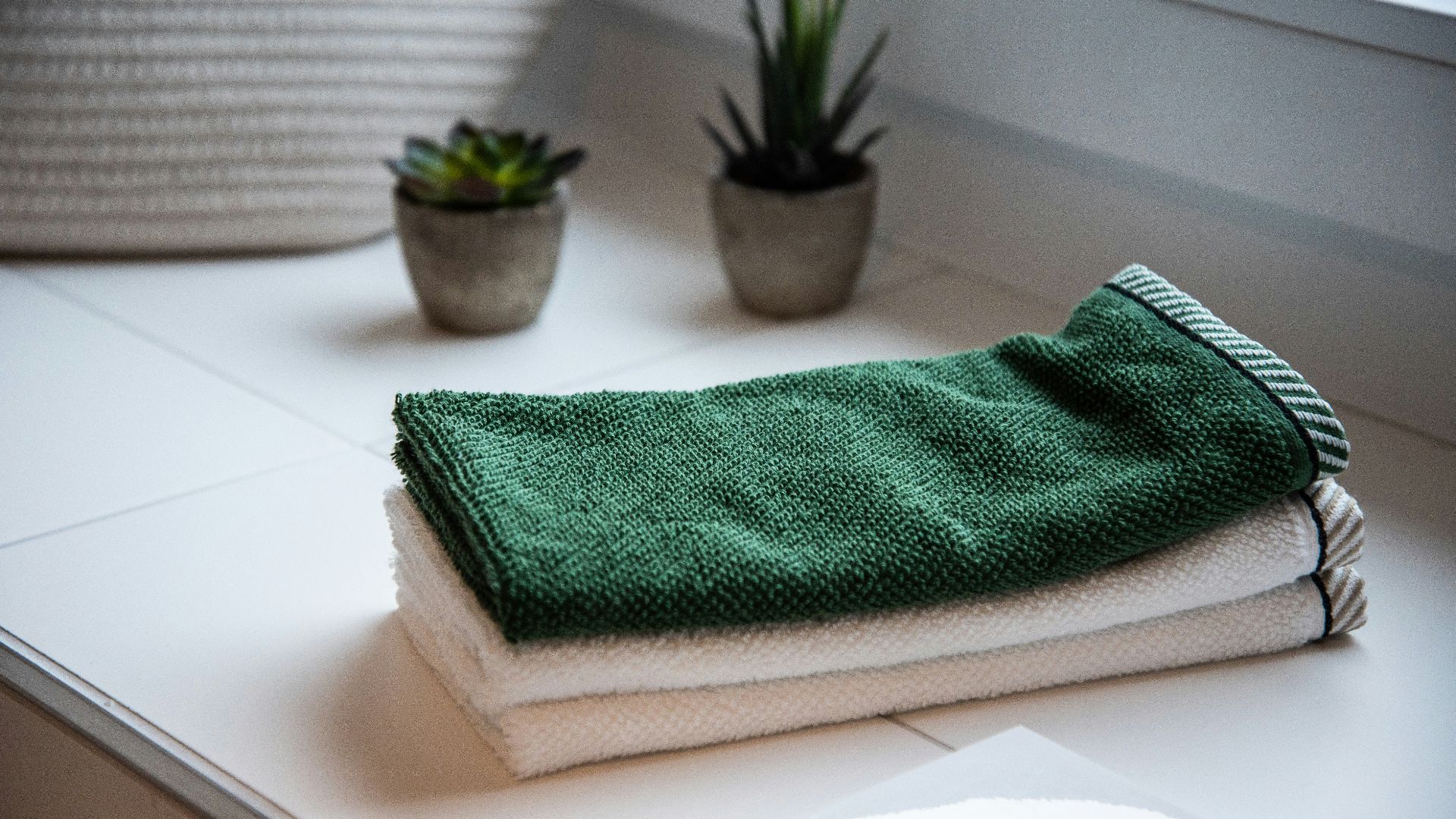 folded towels near potted plants