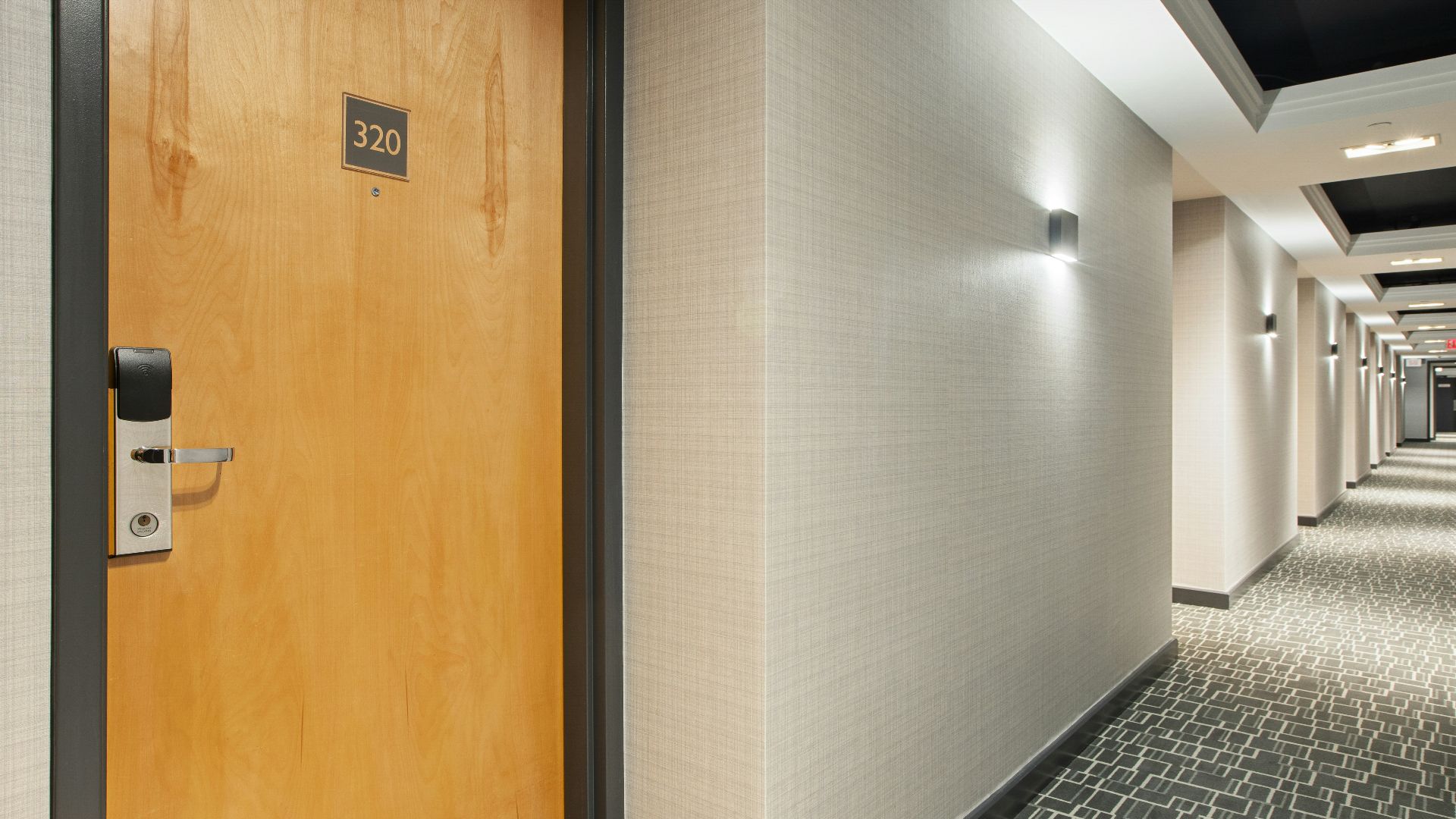 brown wooden door on white and black ceramic tiles
