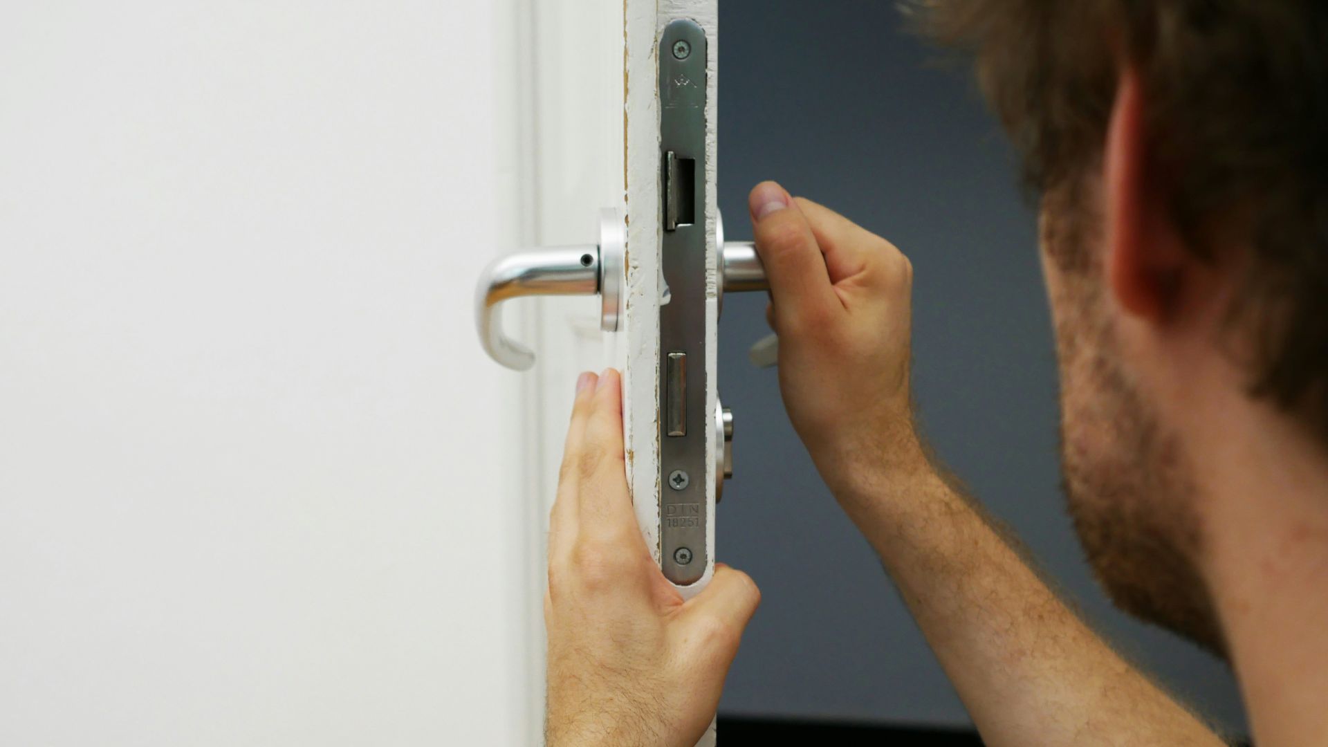 person holds door lever