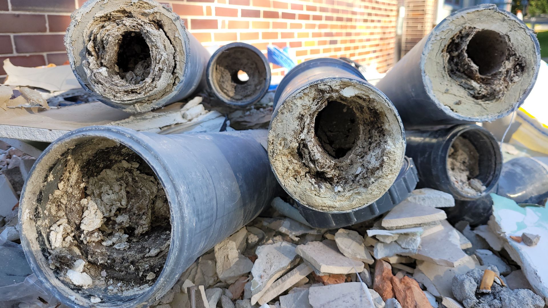 Struvite. Clogged PVC sewage pipes with a diameter of 100 mm.