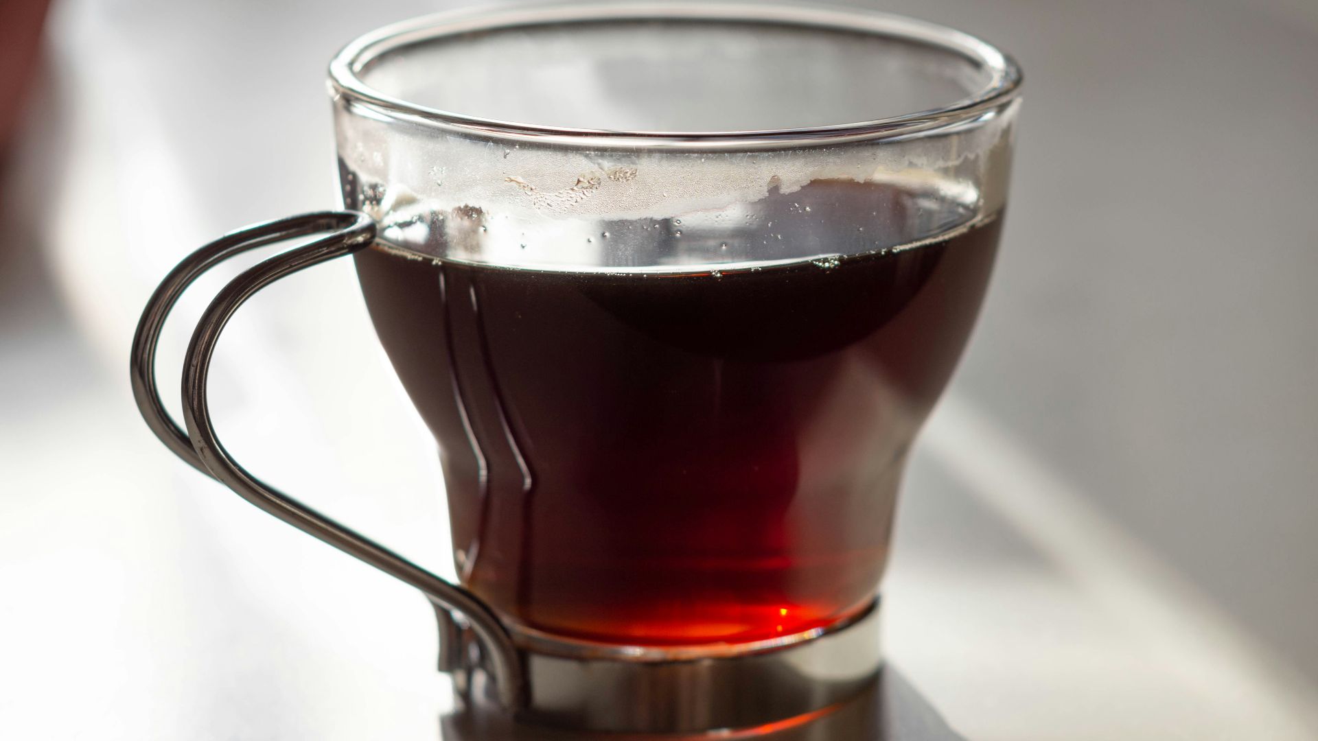 clear glass mug with brown liquid