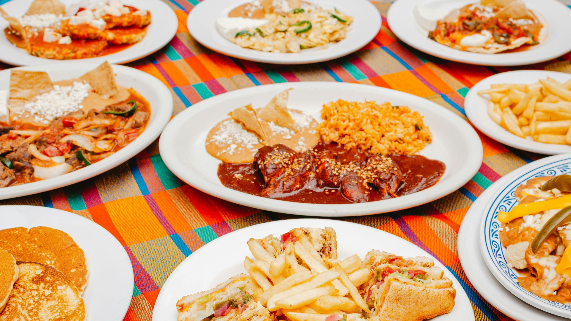 A table topped with lots of plates of food