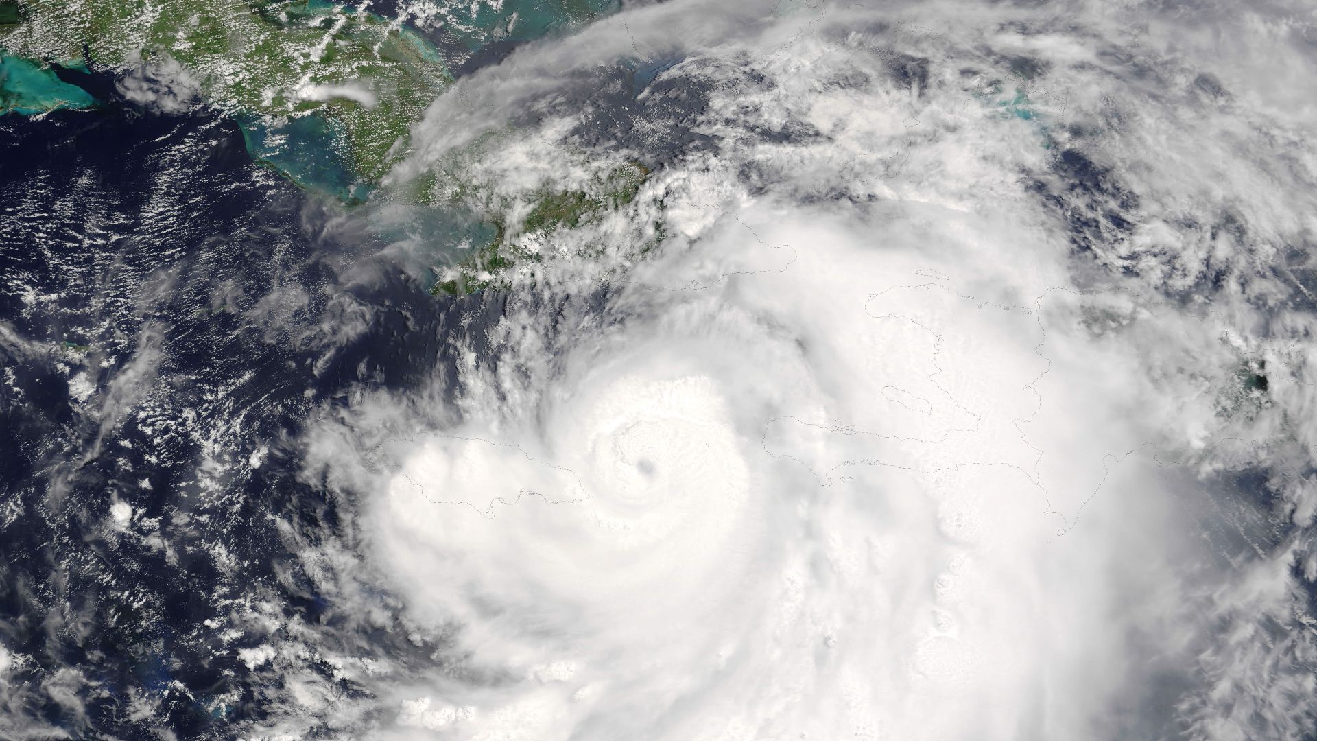 Hurricane Dennis threaded its way between Jamaica and Haiti on a direct course for Cuba on July 7, 2005. The storm now has the distinctive hurricane form, with a well-defined eye surrounded by bands of swirling clouds. At 10:50 a.m. local time (15:50 UTC)