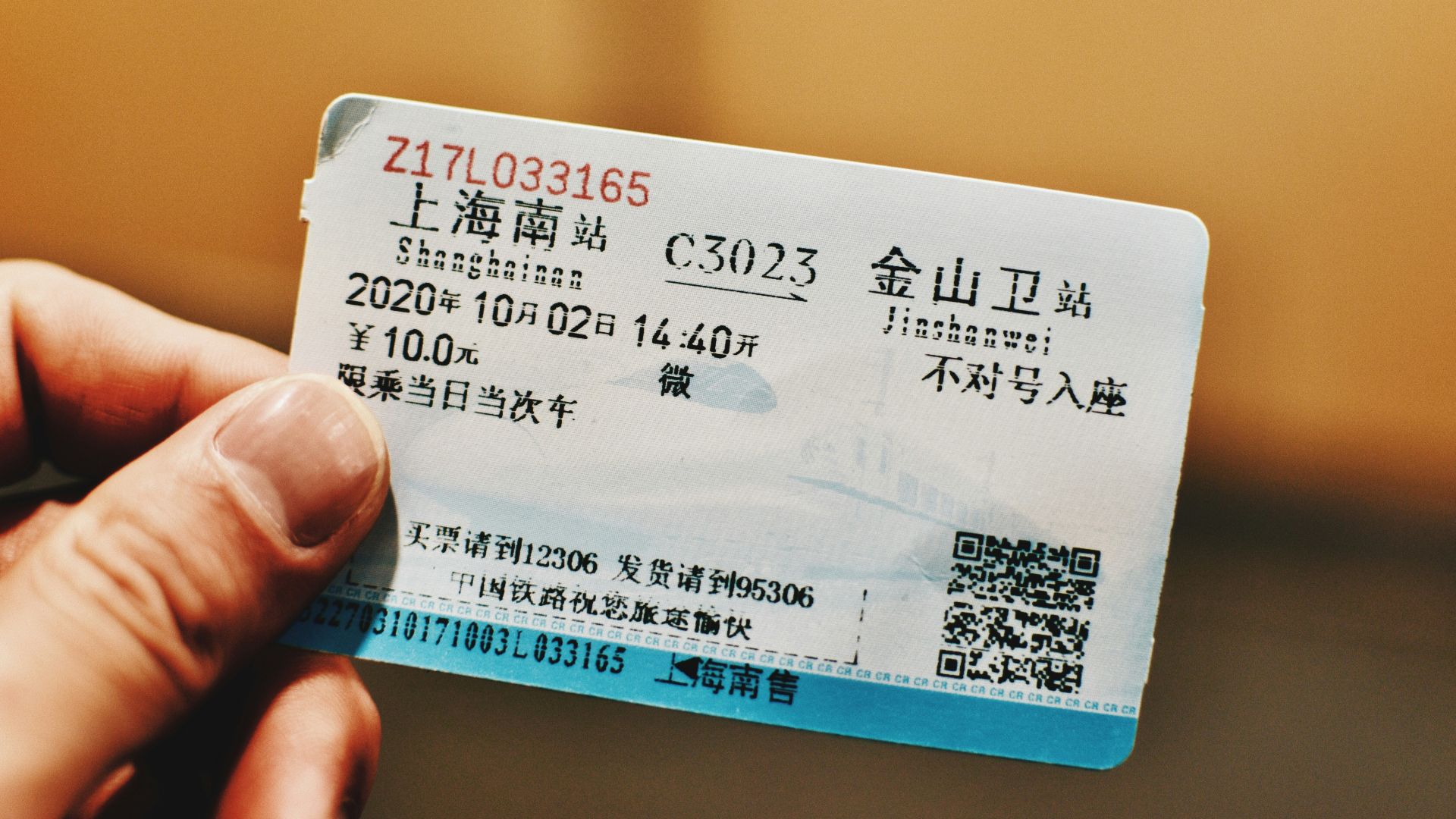 white and blue card on persons hand