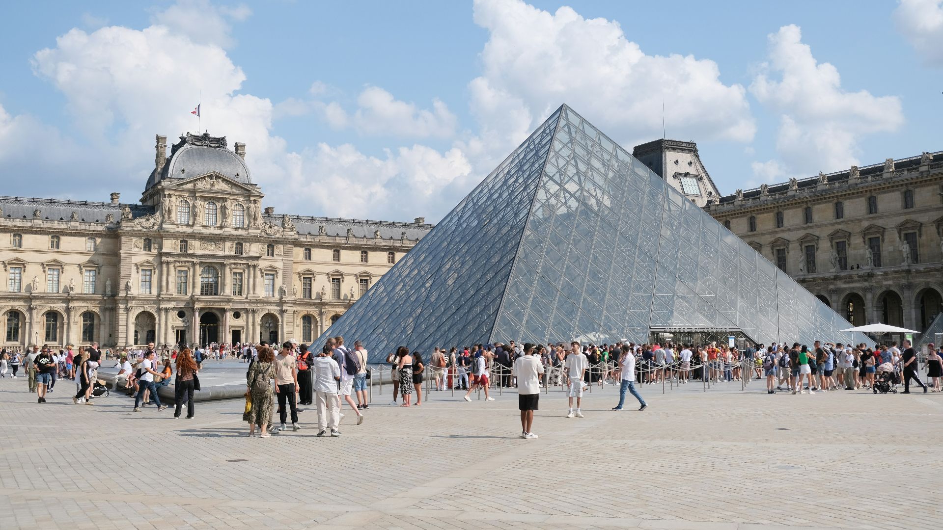 A group of people standing around a large pyramid
