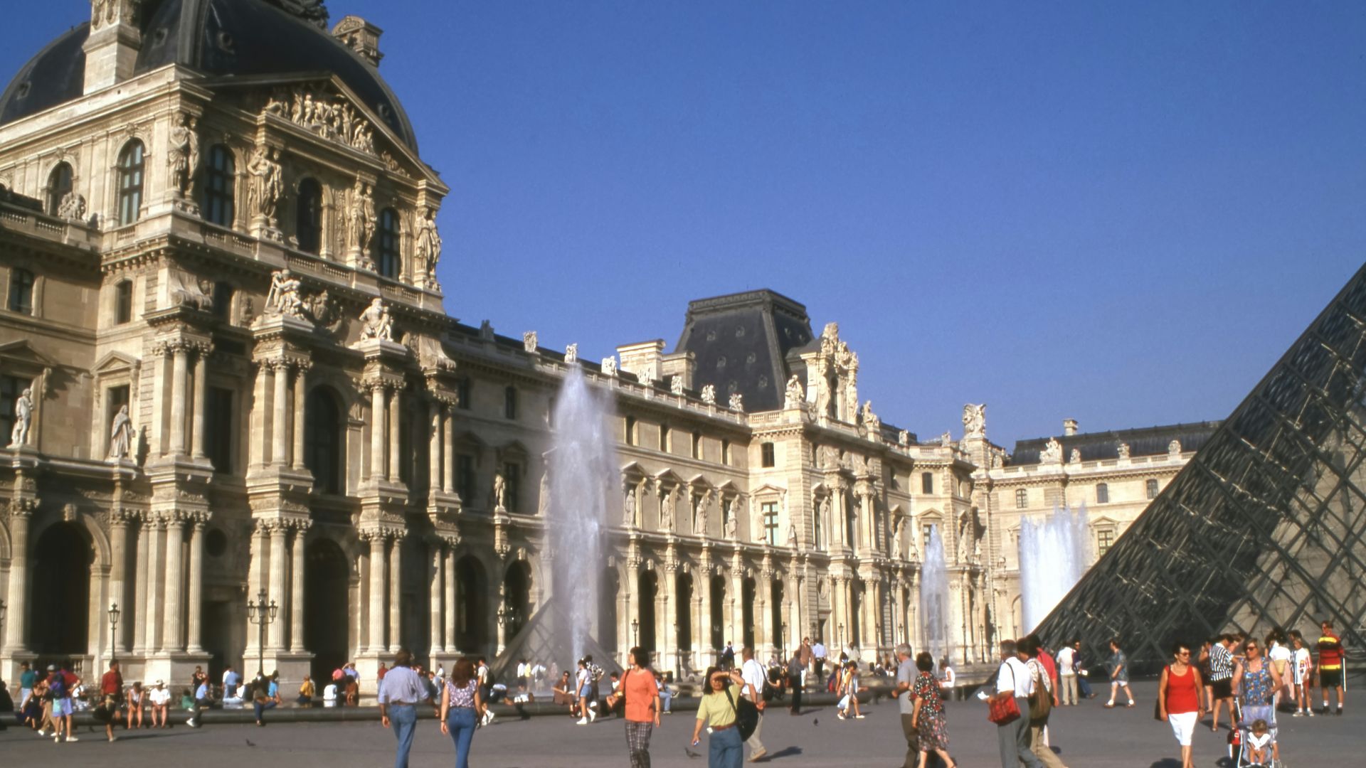 A group of people standing in front of a large building
