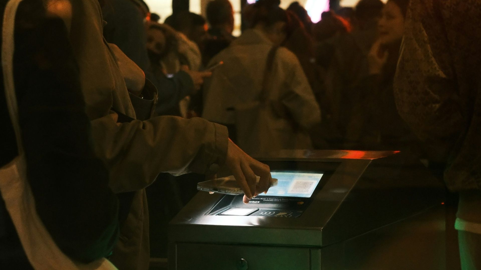 Woman using a ticket gate with green light