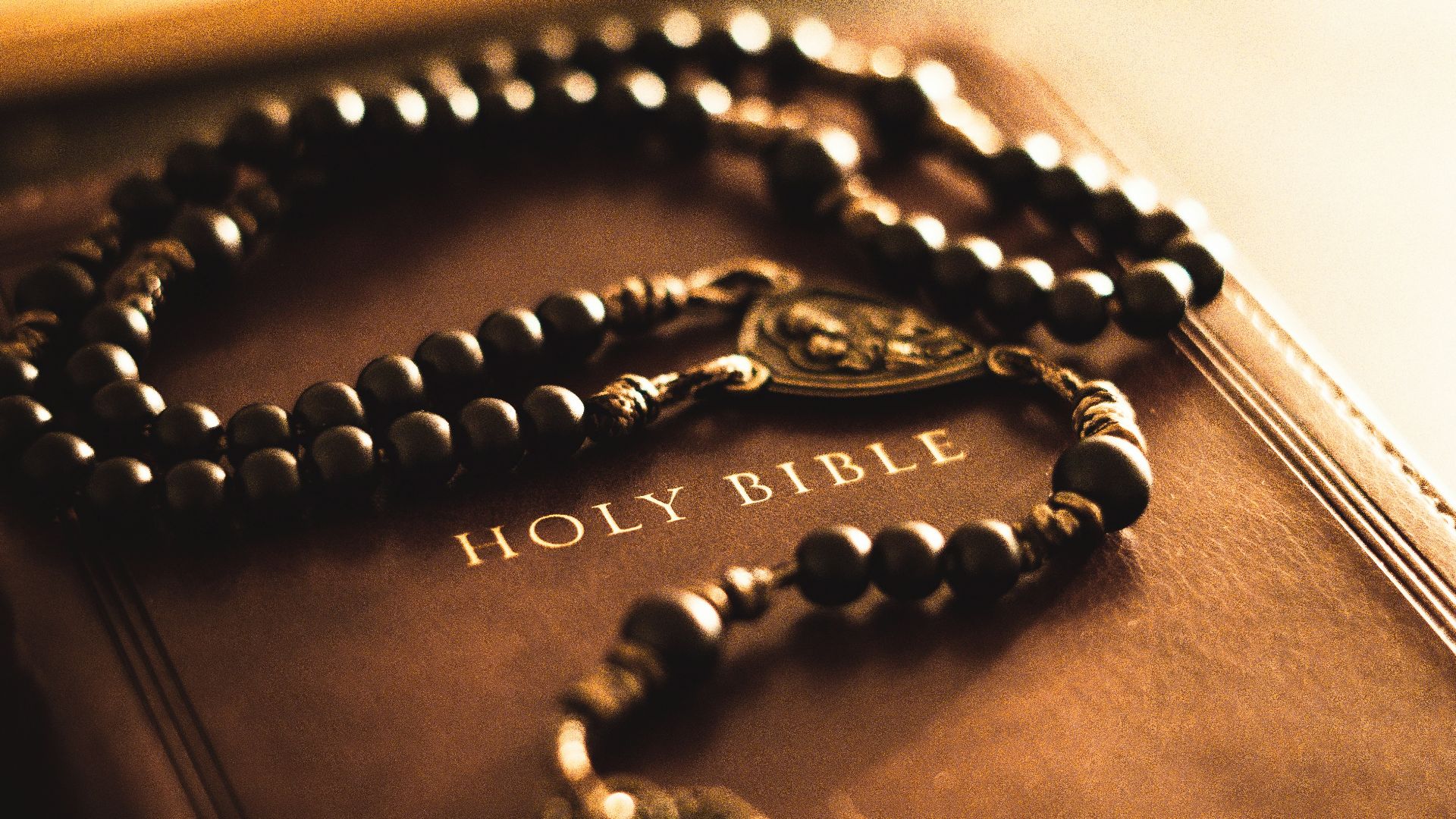 A book with a rosary and a cross on it