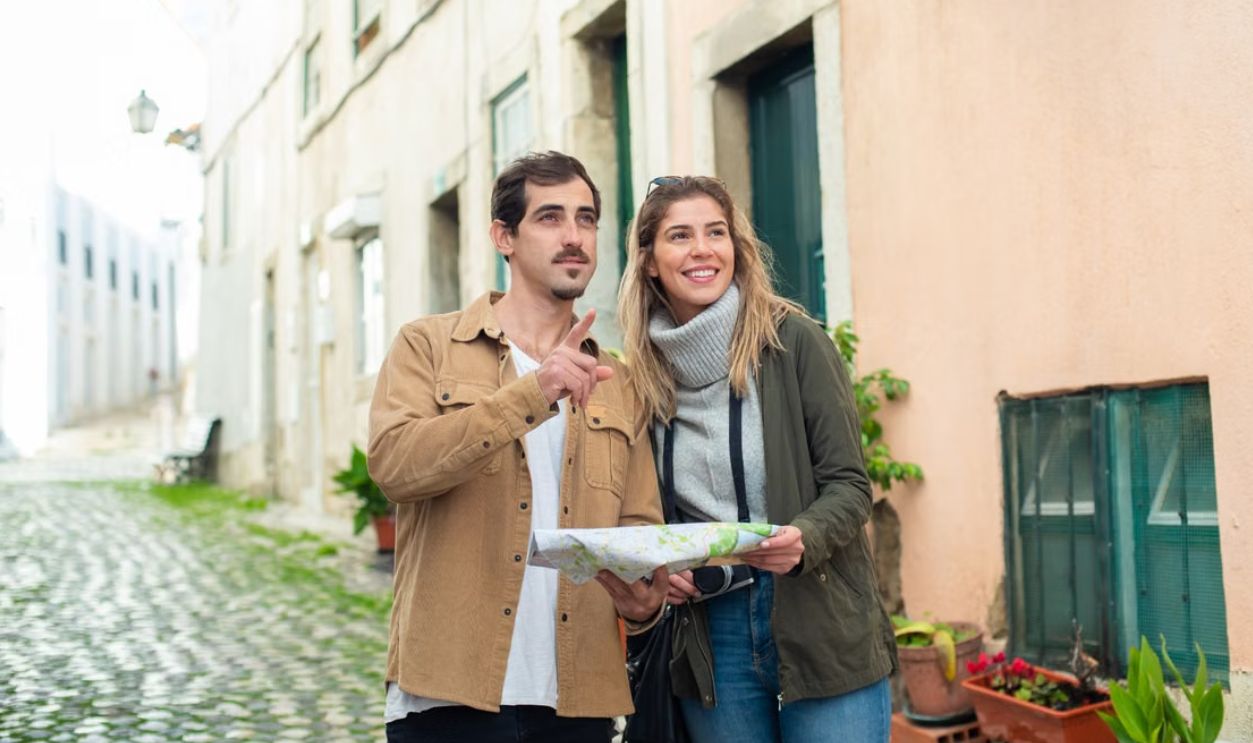 Happy couple exploring a historic city using a map, enjoying a travel adventure together