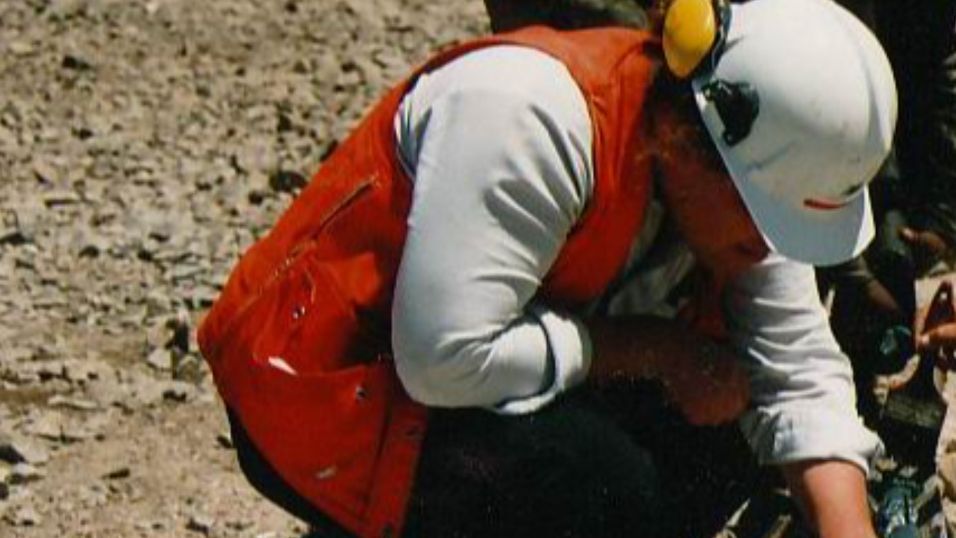 A geologist examining freshly recovered drill-core.
Photo taken by User:Geoz.

Chile, 1994.